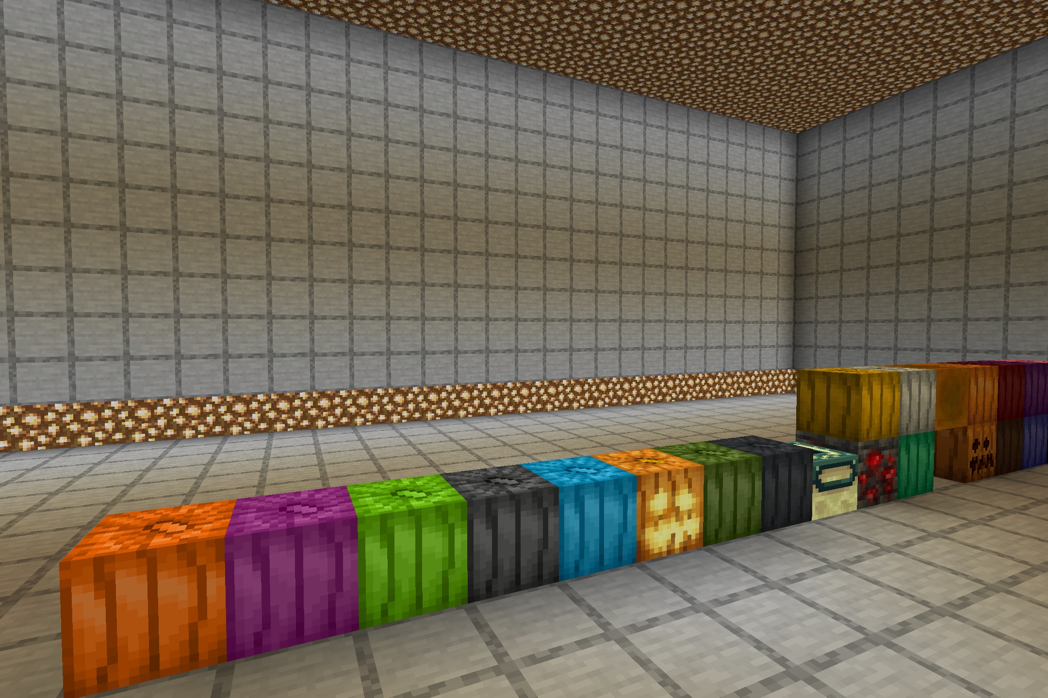 The Night of the Living Pumpkins Resource Pack Screenshot 3 A row of colorful pumpkin blocks displayed in a large stone room