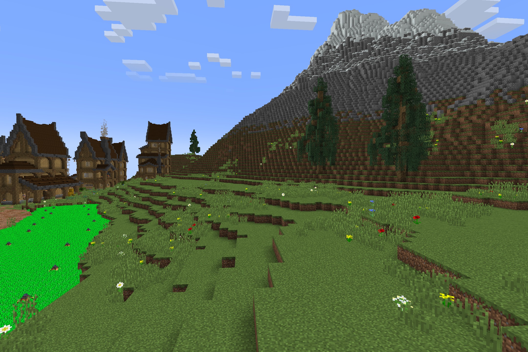 The Original Work Resource Pack Screenshot 2 Grassy hills with flowers and old style houses near a large mountain