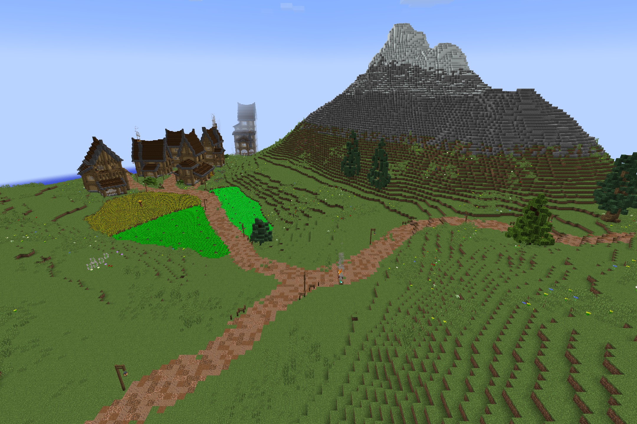 The Original Work Resource Pack Screenshot 6 A small village with rustic houses and farm fields near a large mountain