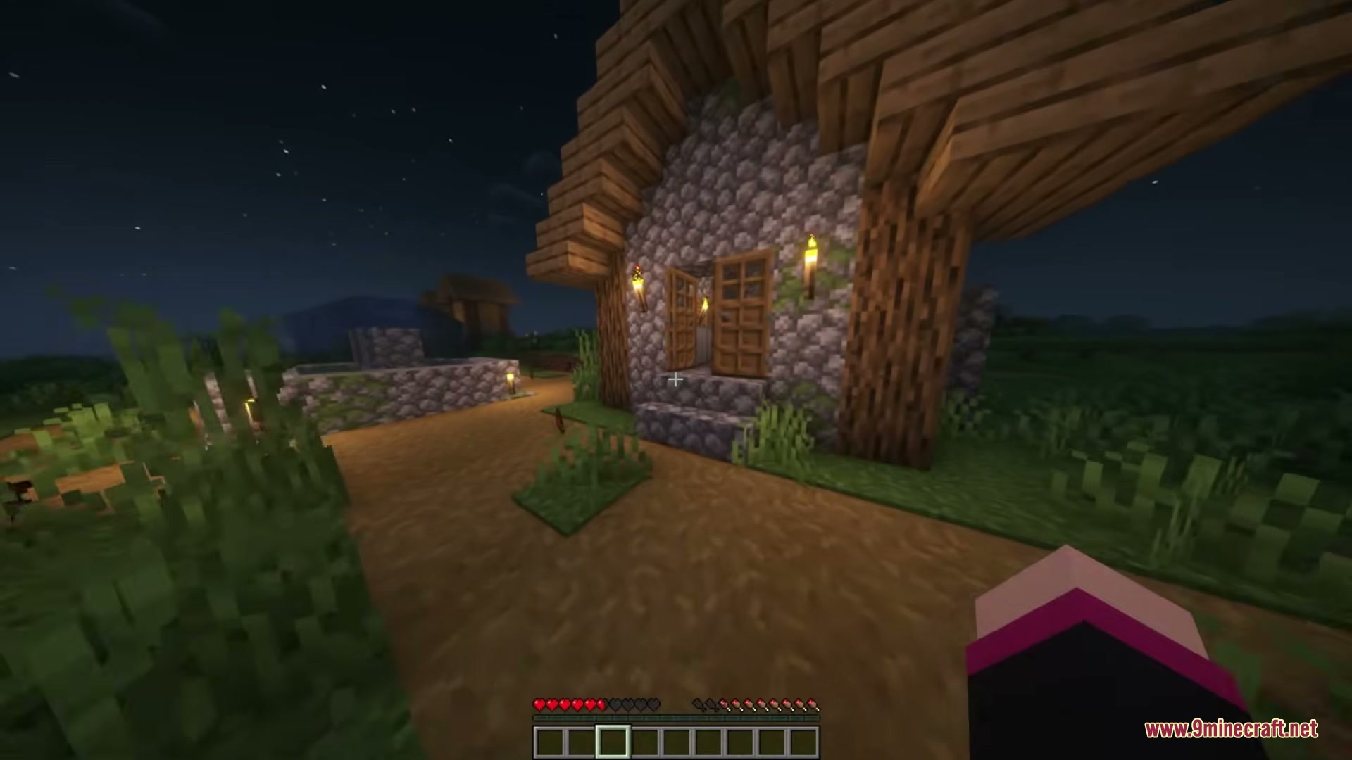 There Are Hot Singles Nearby Resource Pack Screenshot 2 A cozy cobblestone house with torches on the walls in a village