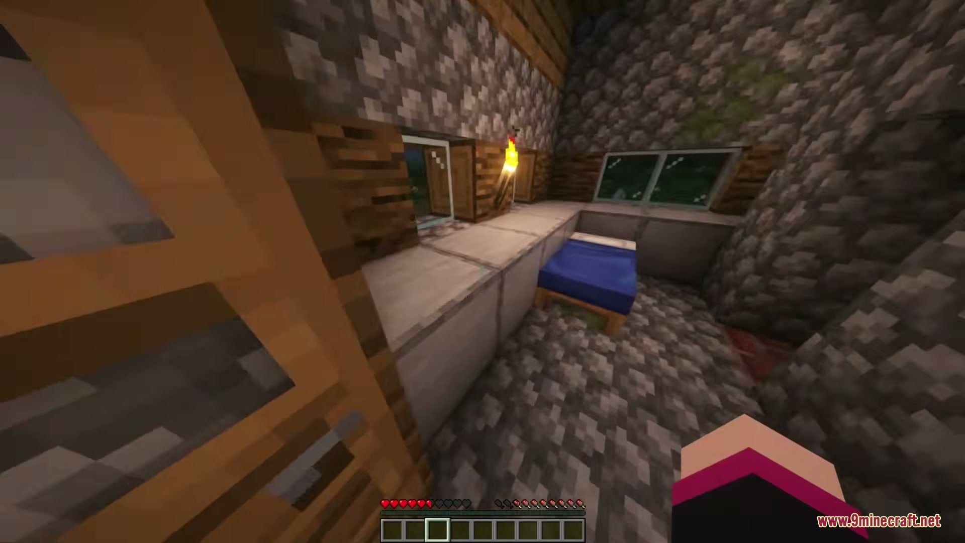 There Are Hot Singles Nearby Resource Pack Screenshot 3 A player standing inside a cobblestone house looking at a blue bed