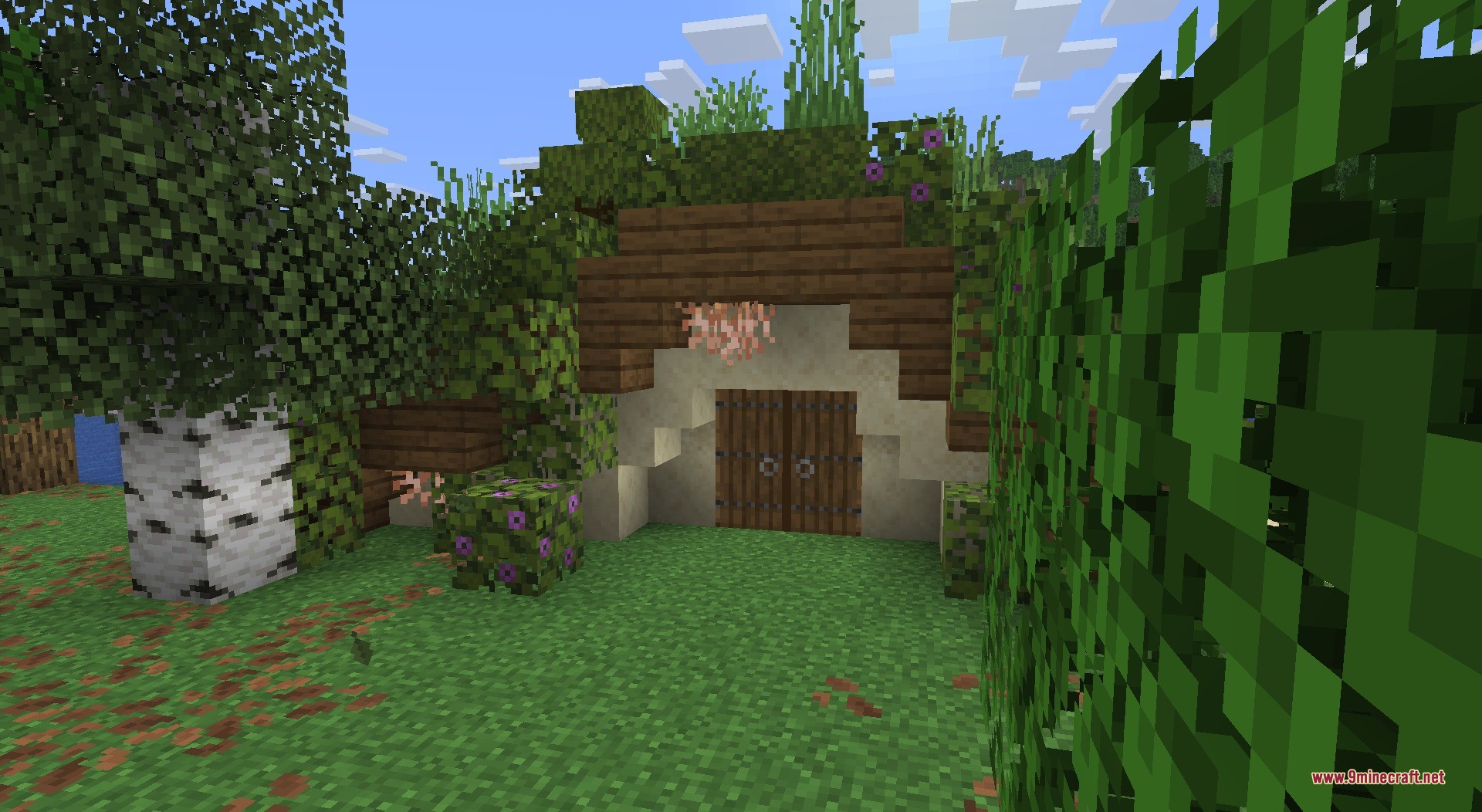 Thun's Structures Data Pack Screenshot 10 A cozy hobbit hole entrance built into a hill with lush greenery