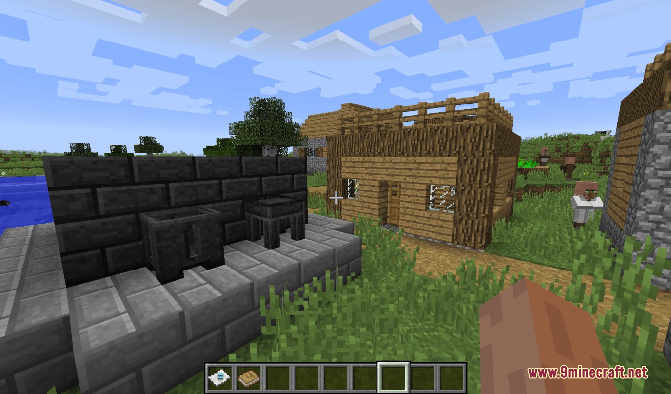 Tinkers' Antique Mod Screenshot 4 A village house next to a dark brick smeltery structure in Minecraft
