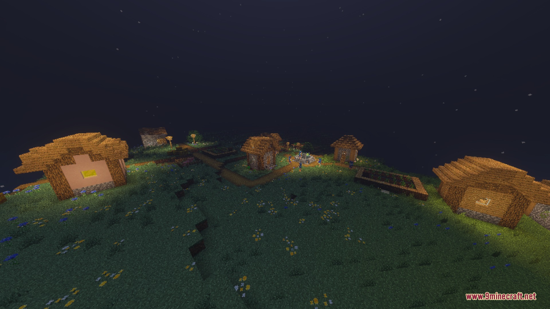 A peaceful village on a hill at night with glowing windows