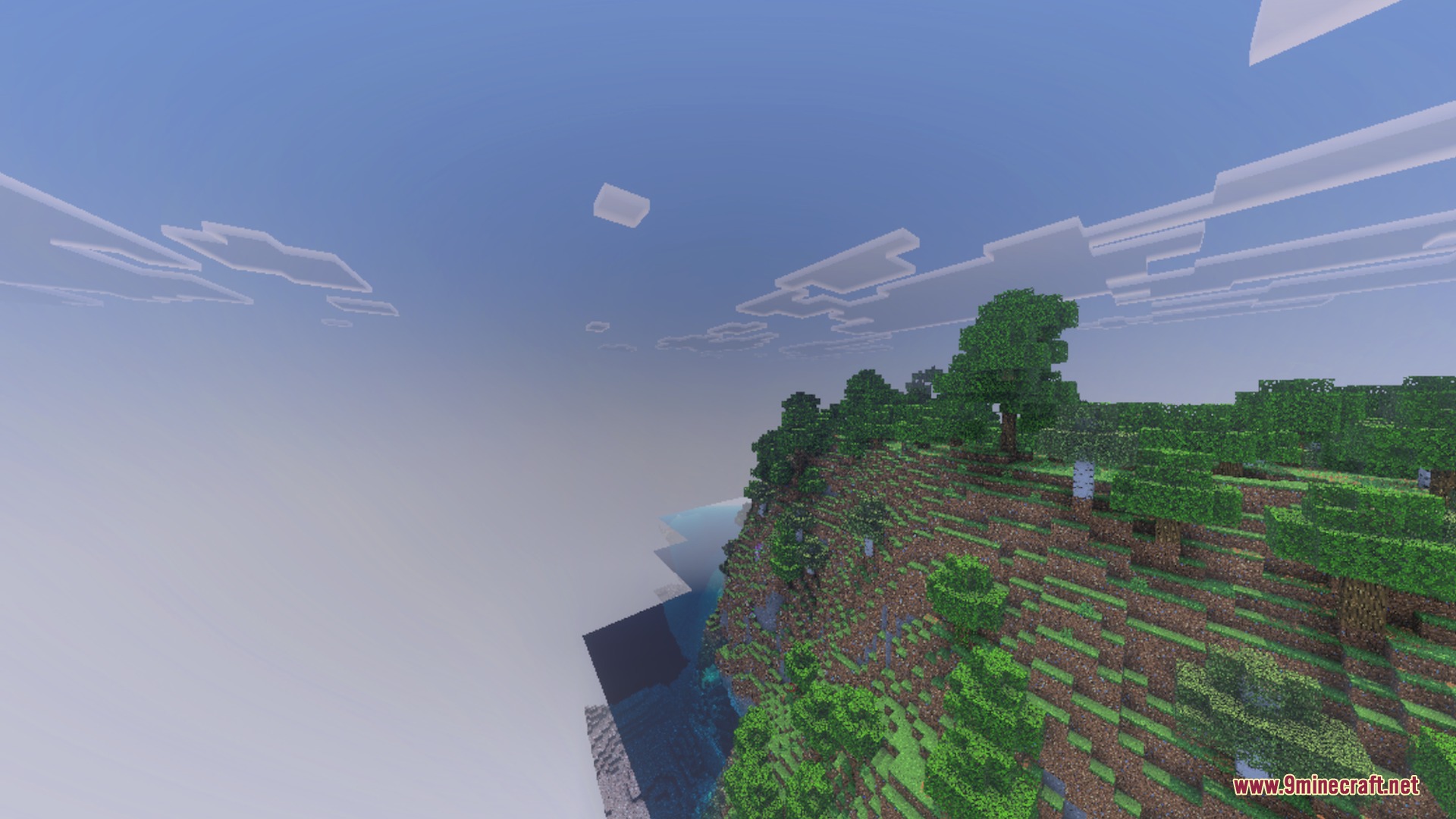 Lush green cliffside with trees overlooking the ocean under a cloudy sky