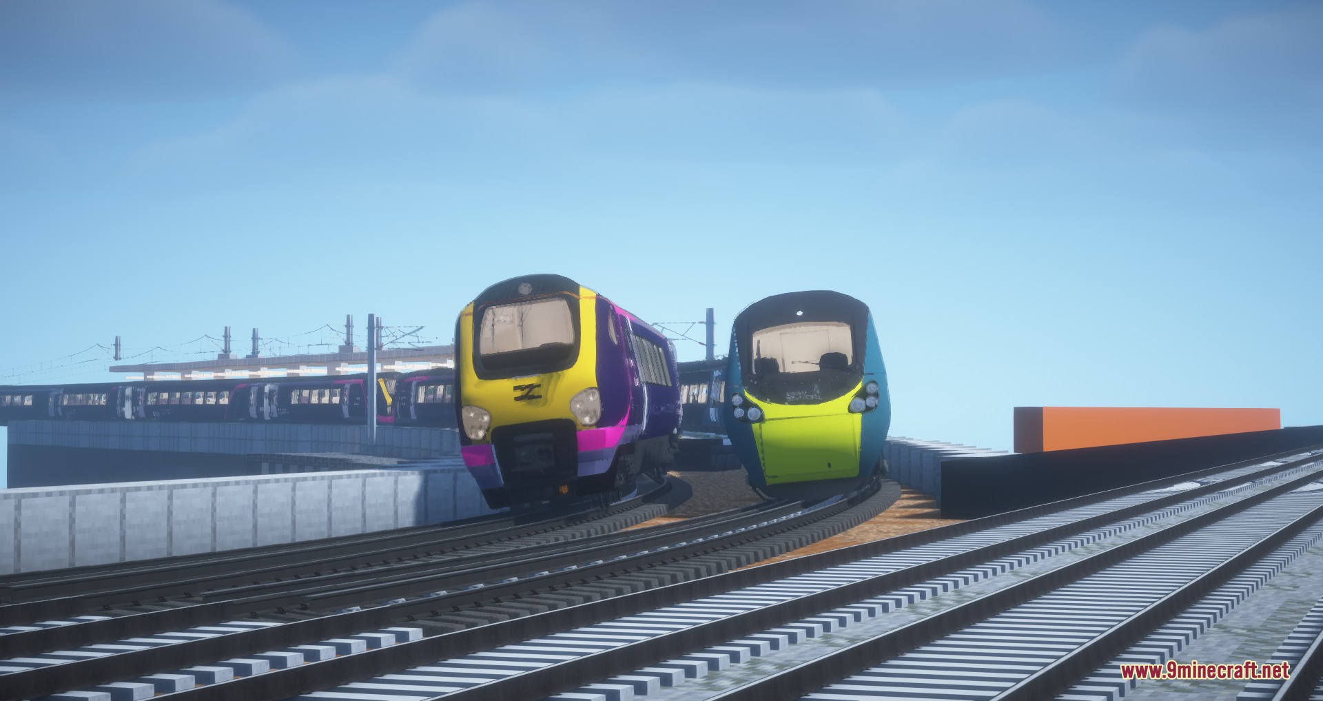 Two colorful trains tilting while navigating a curved track on an elevated railway