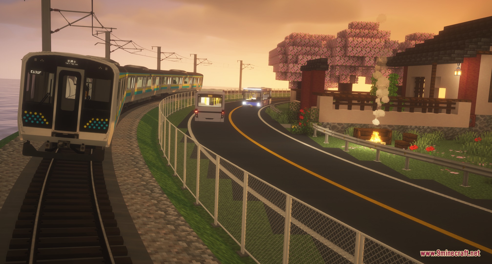 A train traveling along a curved track beside a road during sunset