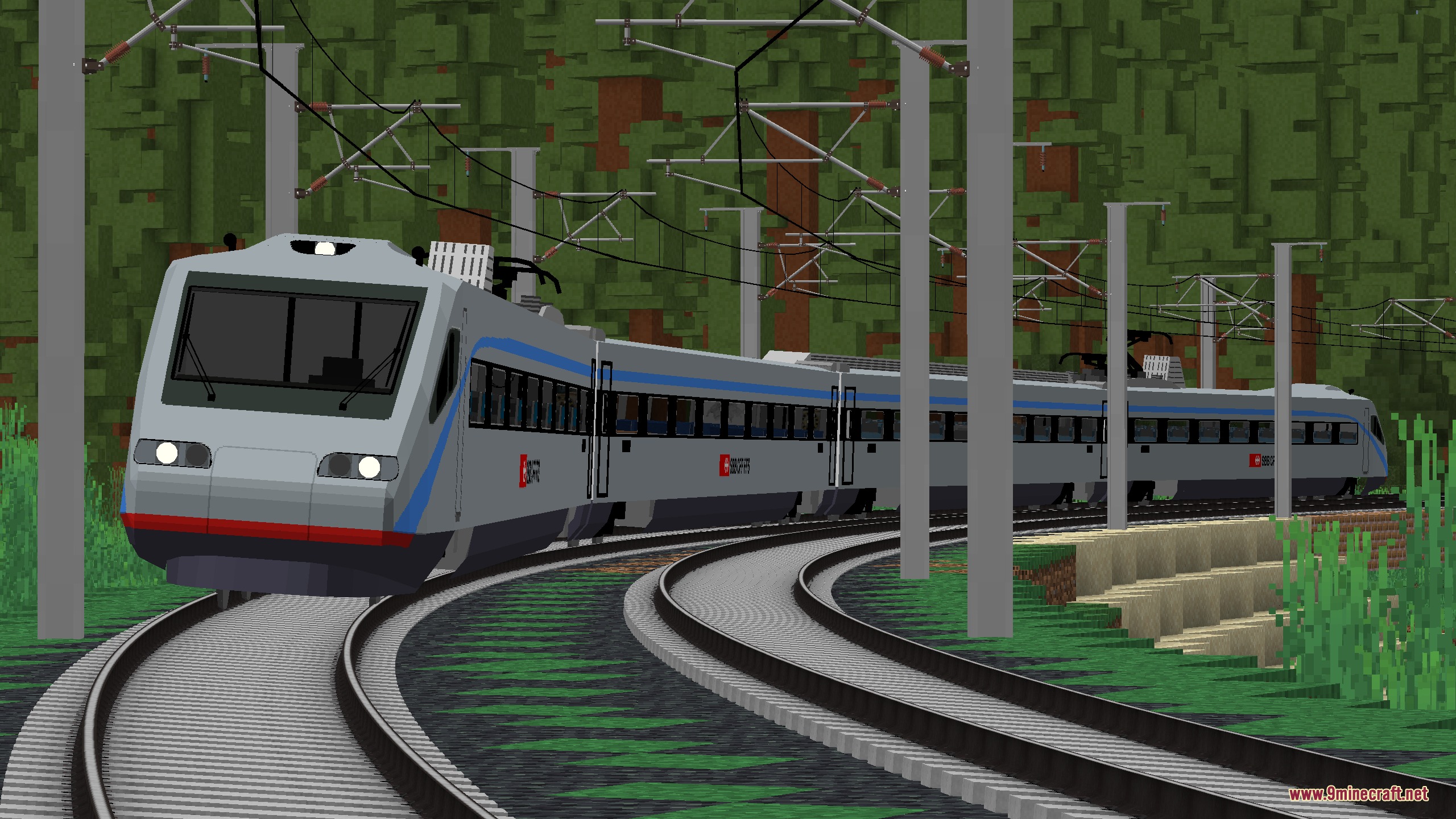 A modern silver train tilting while navigating a sharp curve through a forest