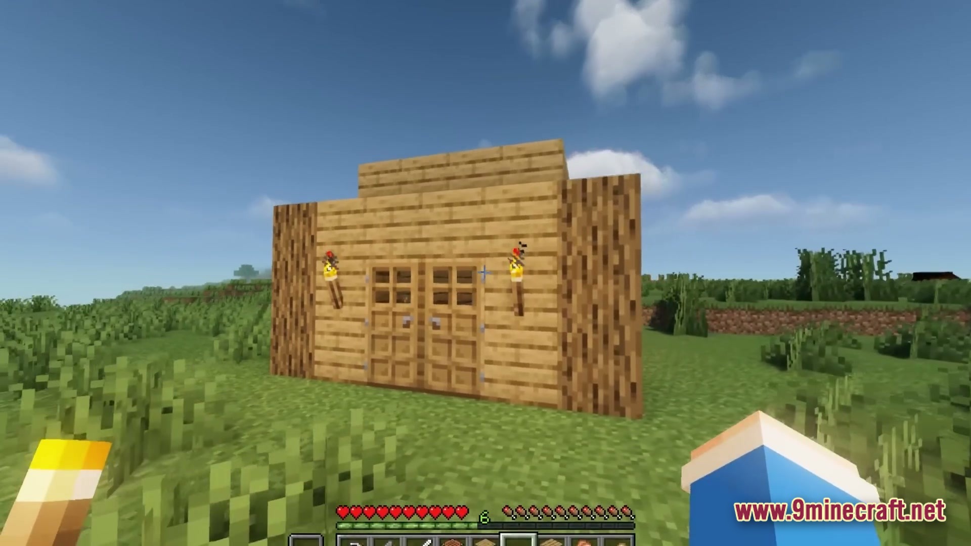 Twixxel's Stalkers Modpack Screenshot 3 A simple wooden wall with double doors and torches stands in a grassy plains biome