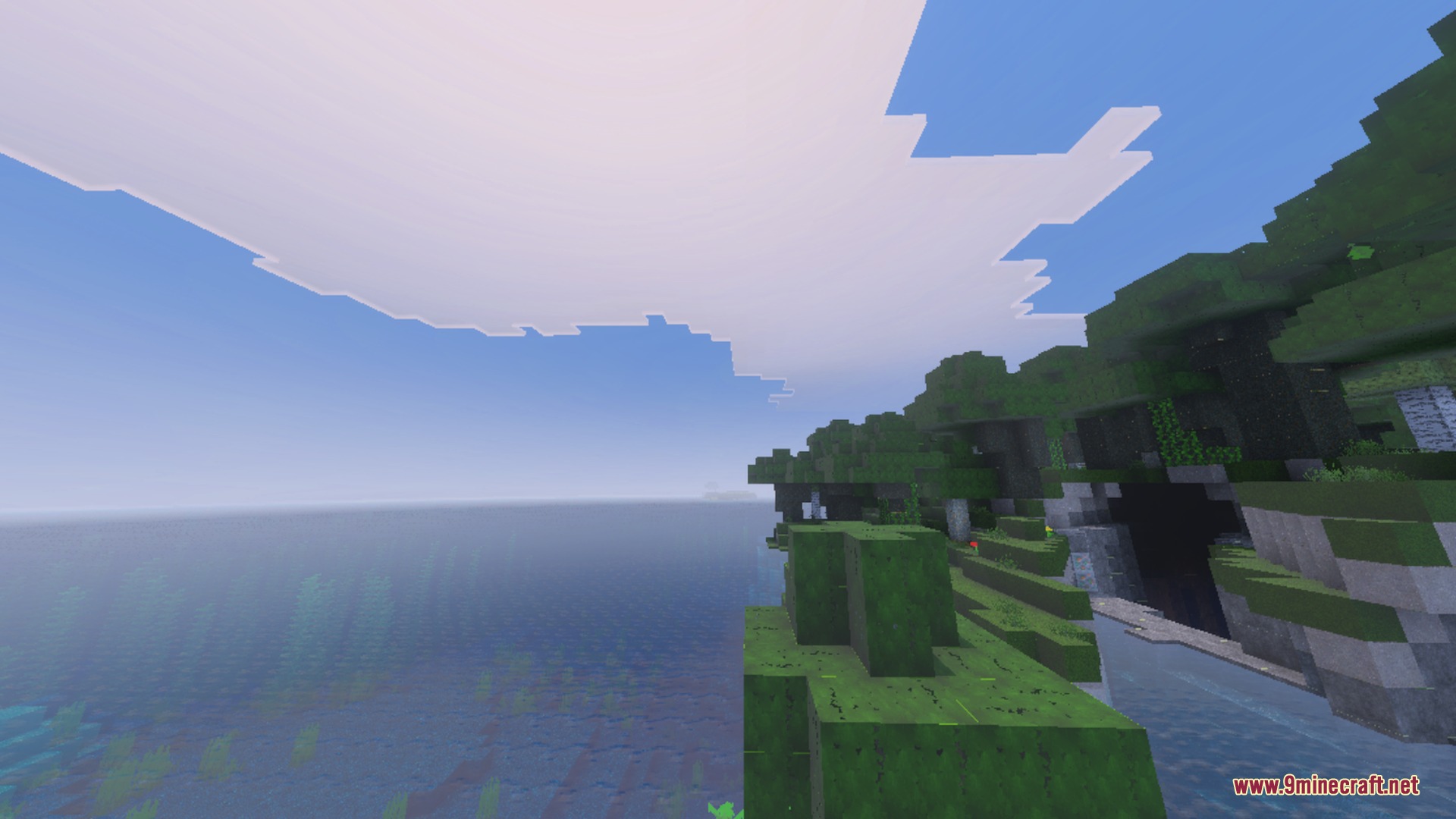 Ultimate Shaders Screenshot 2 Scenic coastal view of lush green cliffs and trees beside a calm ocean