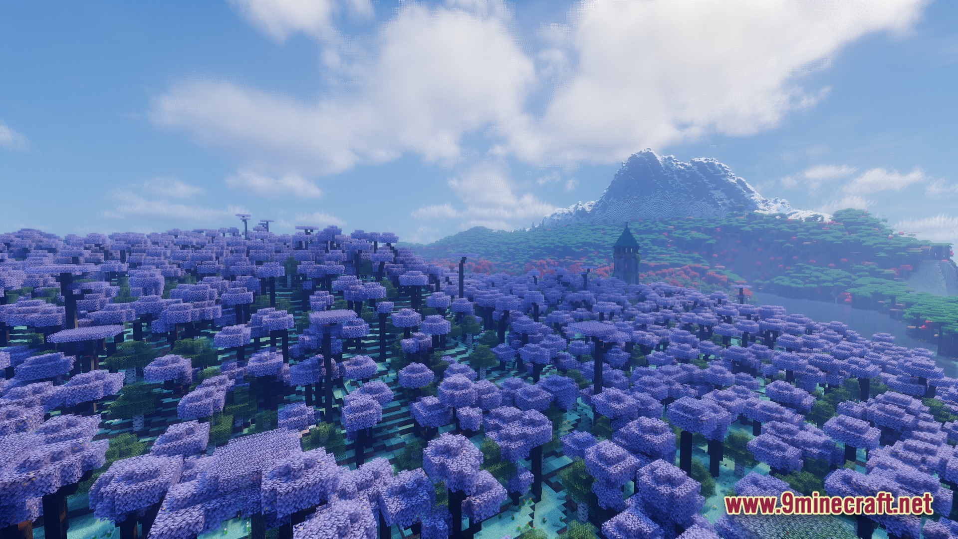 A vast forest of purple-leafed trees stretches toward a distant snow-capped mountain under a bright sky