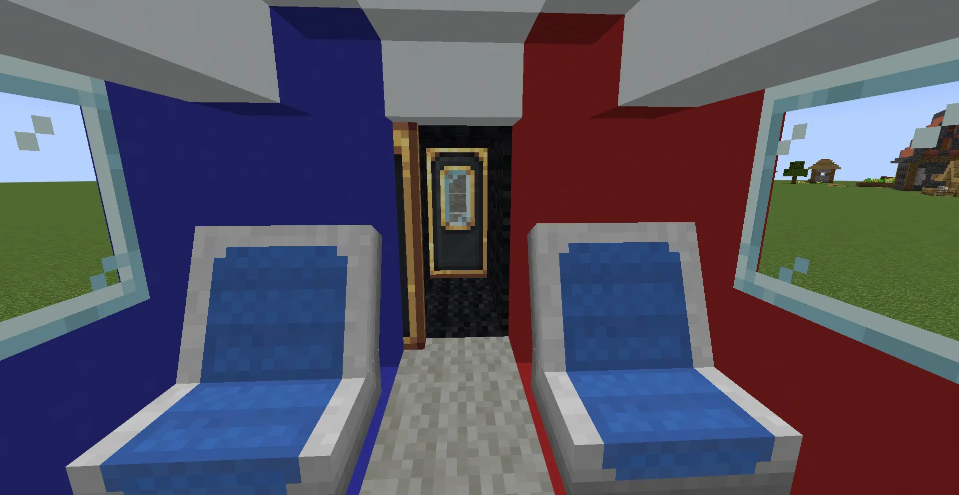Two blue passenger seats inside a train car with red and blue walls