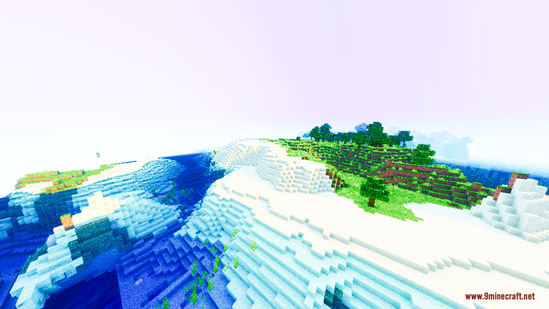 Velora Prism Visuals Shader Screenshot 8 Vibrant green grass and trees meet snowy hills beside a clear blue ocean