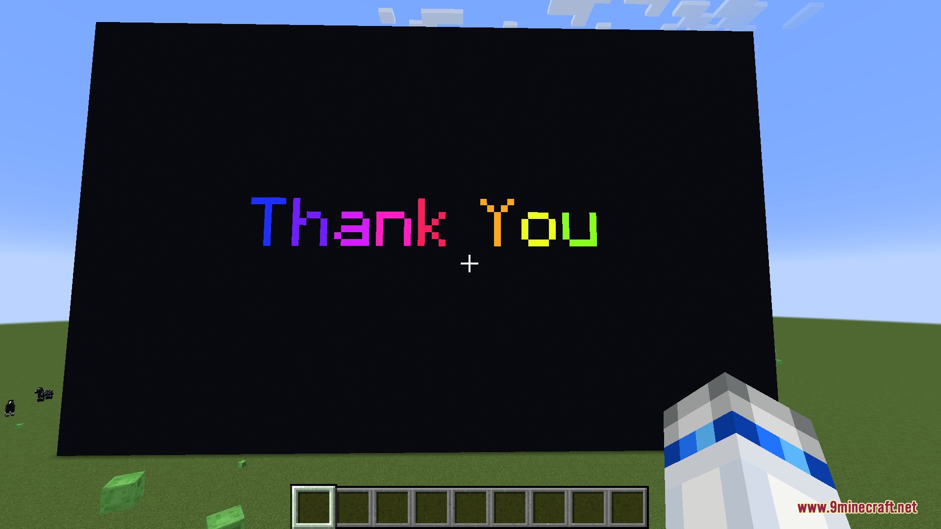 Vibe Wire Audio Mod Screenshot 8 A large LED screen displaying scrolling rainbow text in a flat Minecraft world