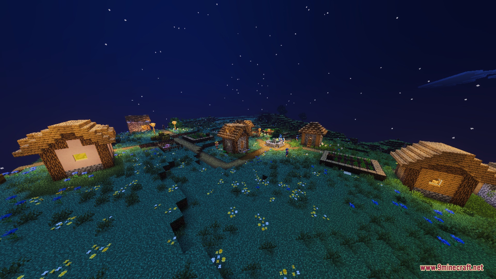 Warm lanterns illuminate a small village under a vibrant deep blue night sky