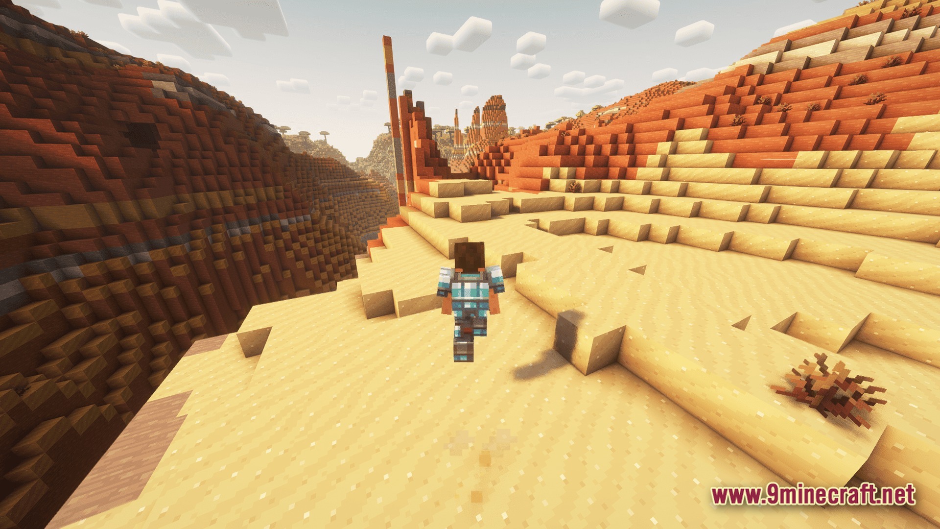 Vivid Kinetic Ether Modpack Screenshot 9 A player character wearing blue armor walks through a vast desert biome with red rock formations