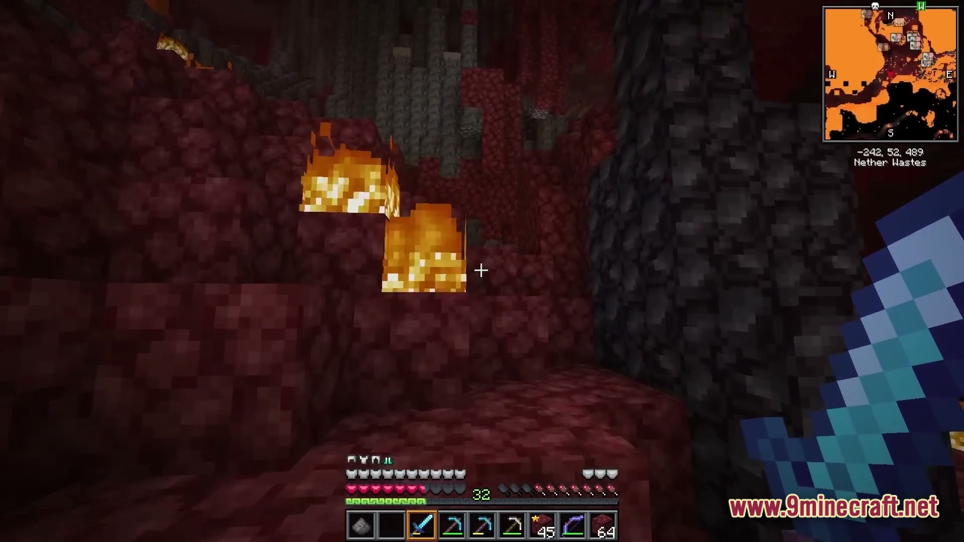Vividia Horizon Modpack Screenshot 4 A player explores the Nether Wastes biome while holding a diamond sword near netherrack and fire