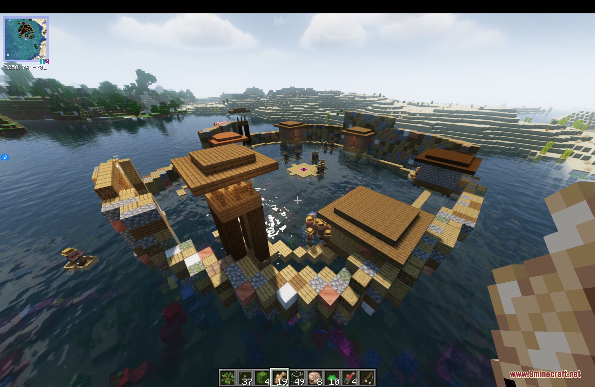 Water World Atolls Mod Screenshot 1 Aerial view of a circular atoll settlement with wooden walkways and stilt huts