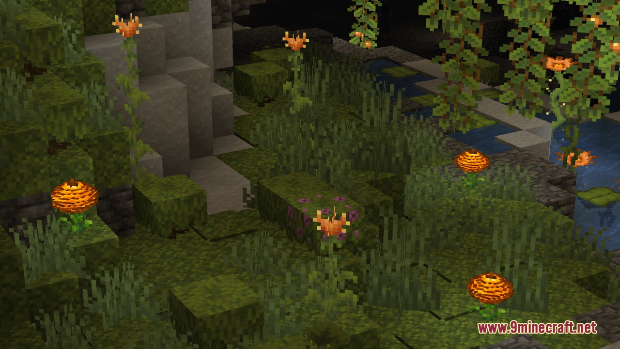 Glowing orange plants and flowers growing inside a lush Minecraft cave