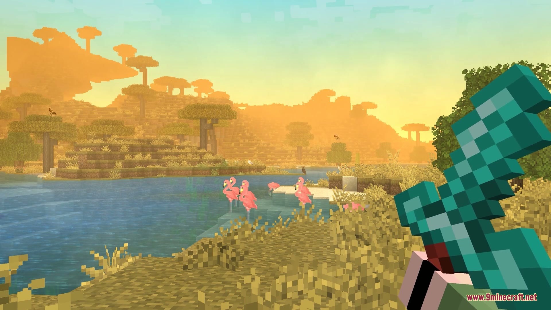 Wildwood Echoes Mod Screenshot 1 Pink flamingos standing in a savanna lake at sunset while player holds diamond sword