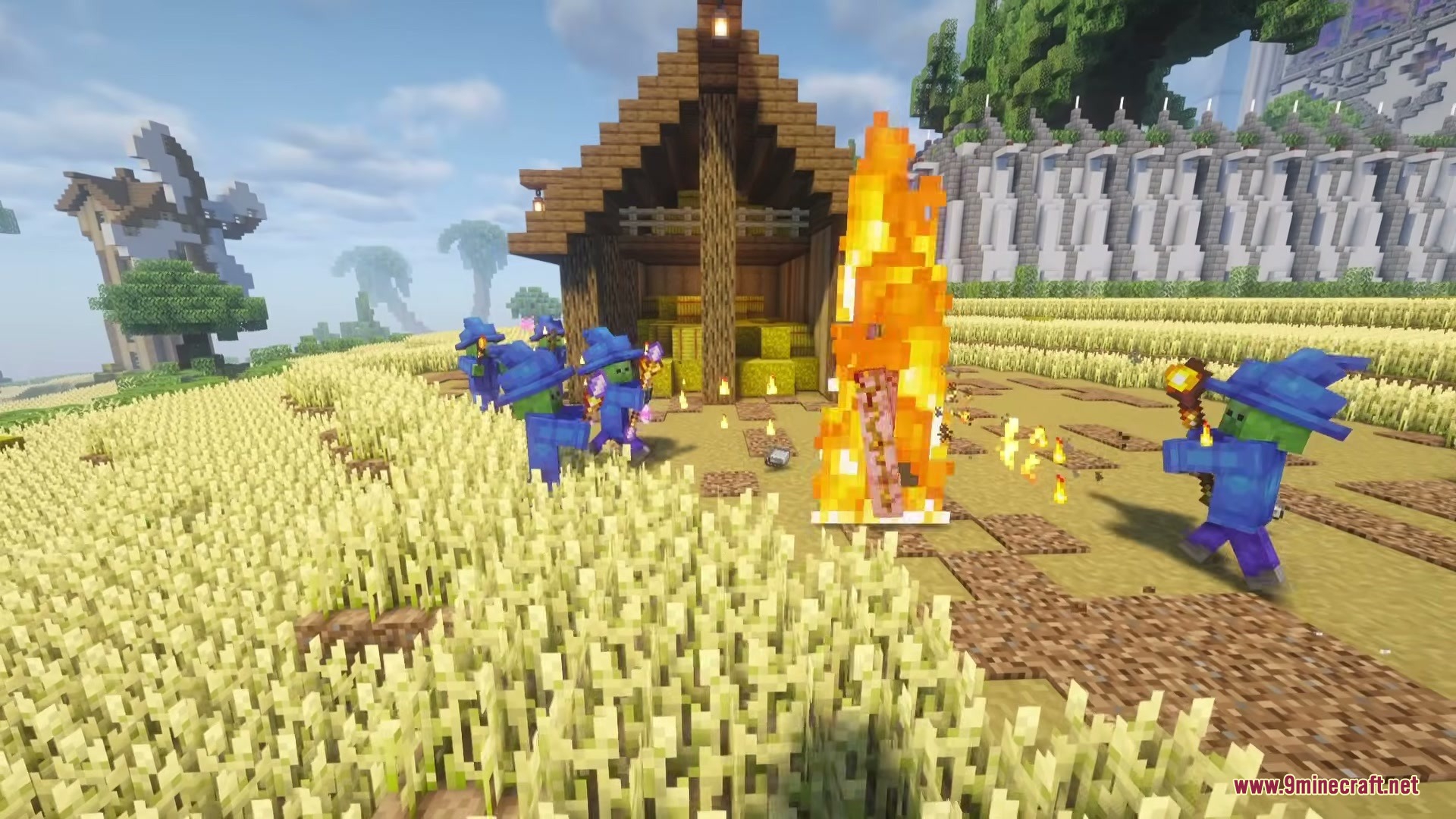 Wizard Mobs Mod Screenshot 2 Undead magic casters in blue robes surrounding a fire near a hay barn