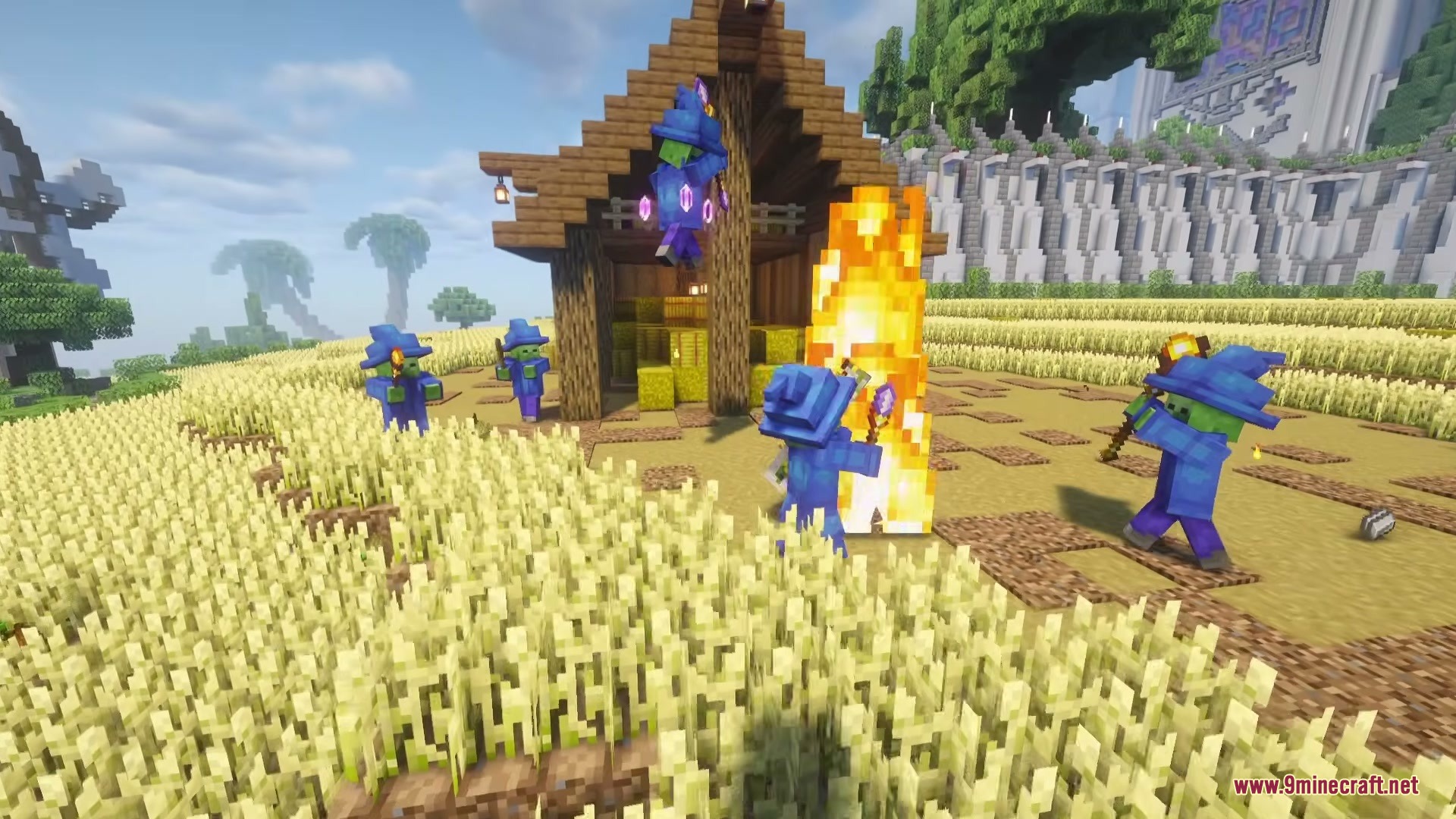 Wizard Mobs Mod Screenshot 3 Undead spellcasters in blue robes roaming through a golden wheat farm
