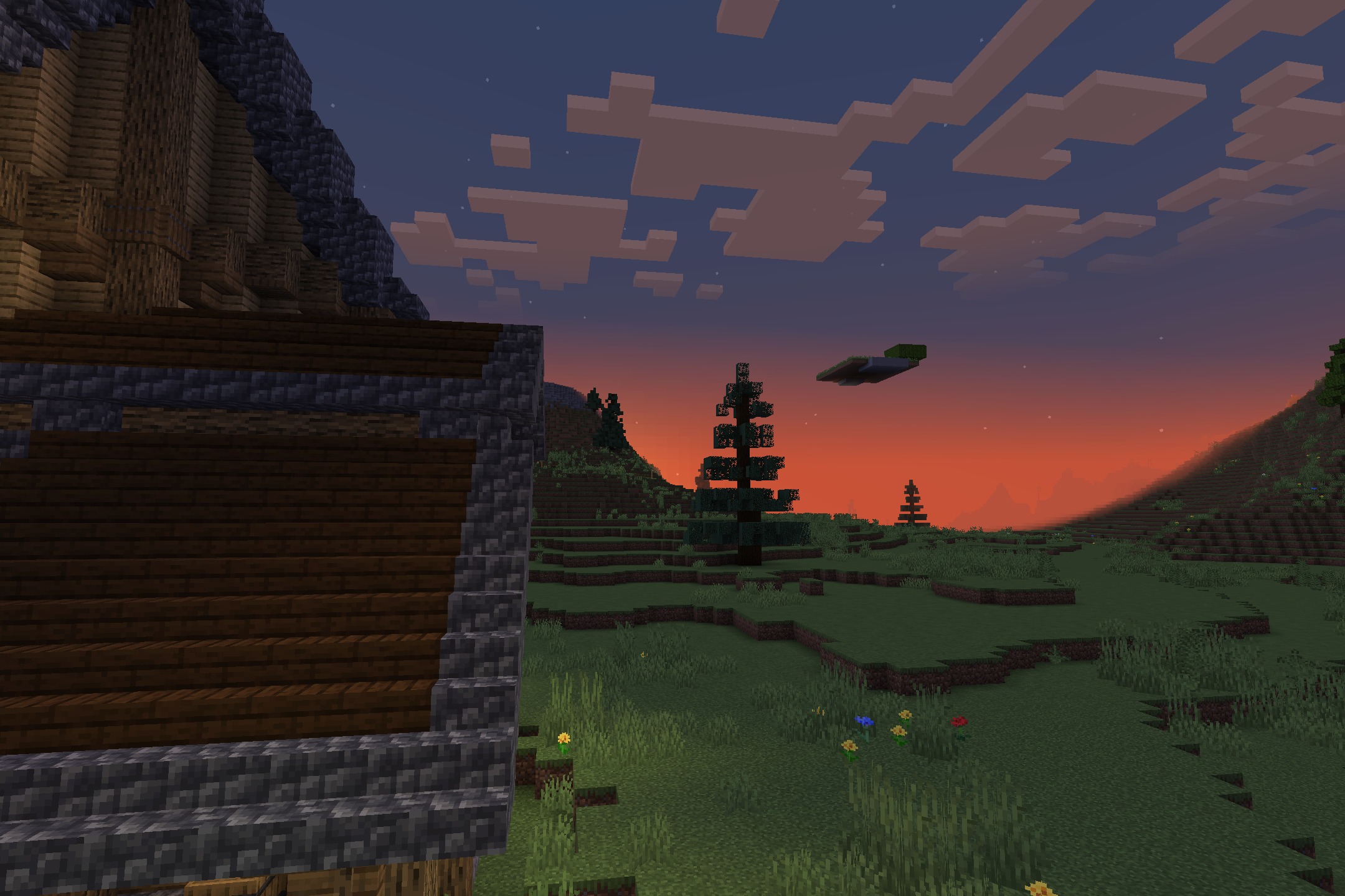Wolfhound Classic Medieval Resource Pack Screenshot 10 A medieval building roof overlooking a grassy field with spruce trees at sunset