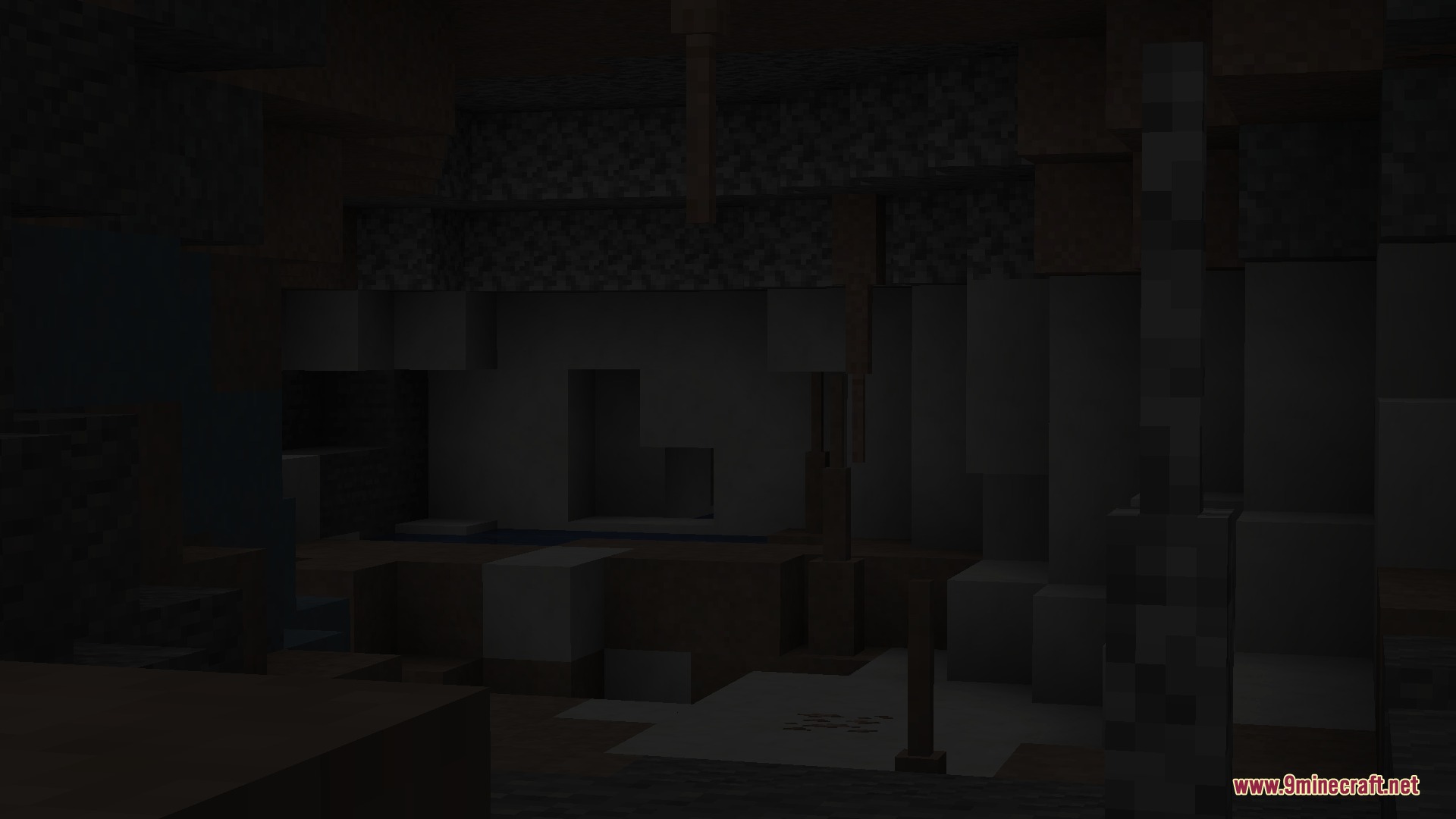 Dark cave interior featuring diverse stone blocks and hanging stalactite decorations