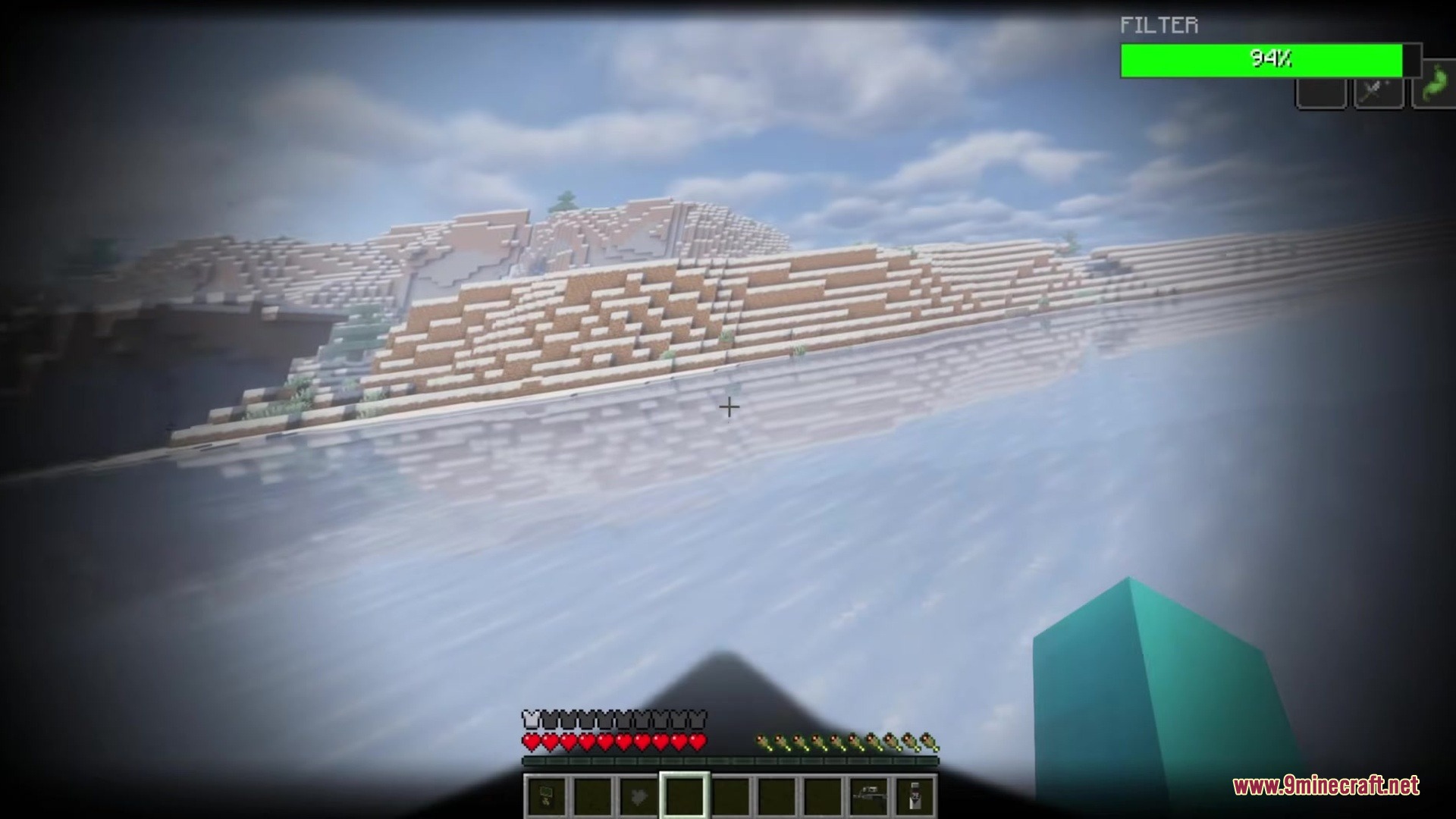 Player wearing a gas mask with a filter bar looking at snowy terrain