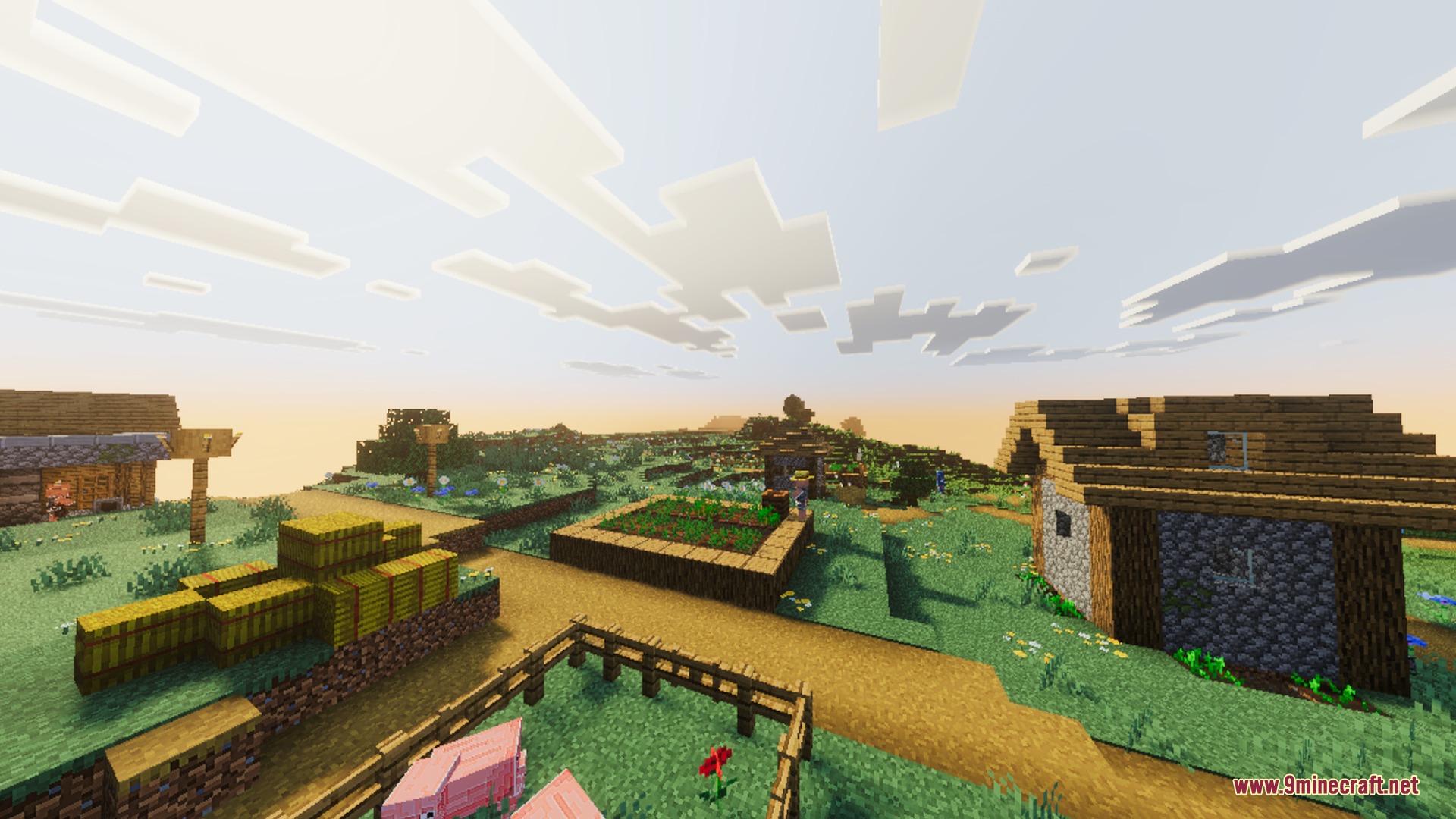 Peaceful village scene with hay bales and pigs under a bright golden sky
