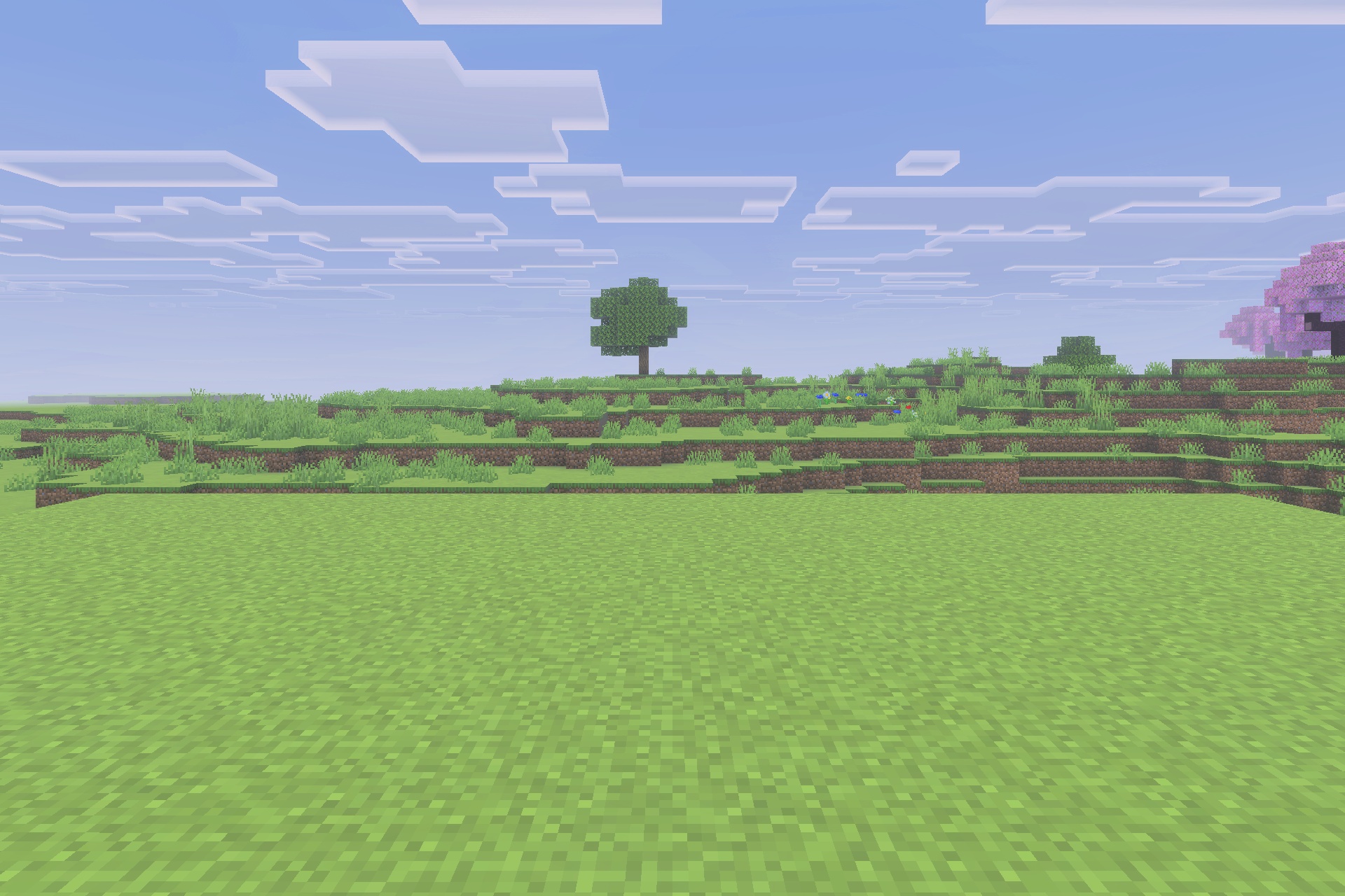 Xnova Remastered Texture Pack Screenshot 3 A vast green Minecraft landscape featuring a single tree under a cloudy sky