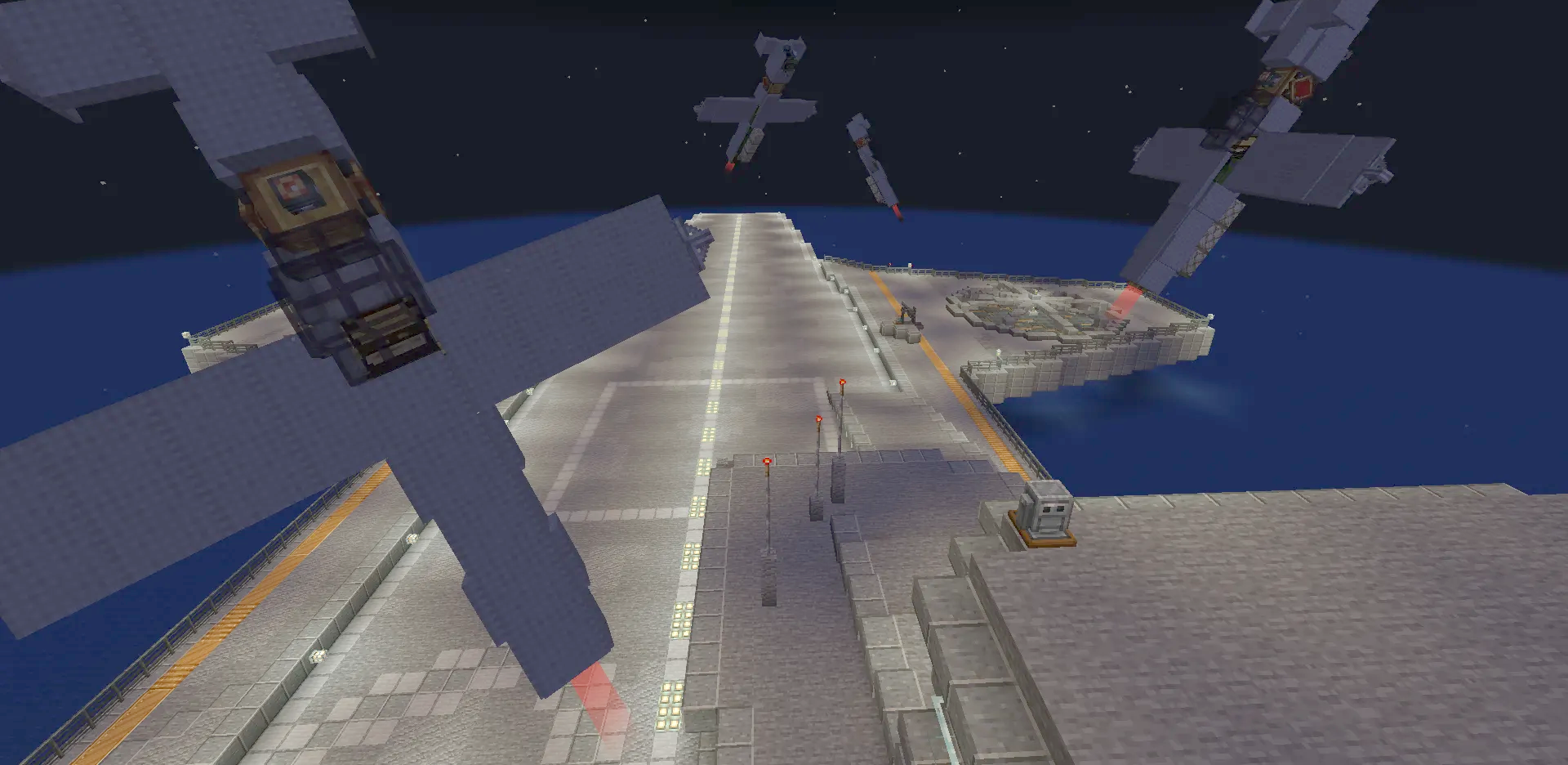 Several kamikaze planes flying over a lit aircraft carrier deck at night