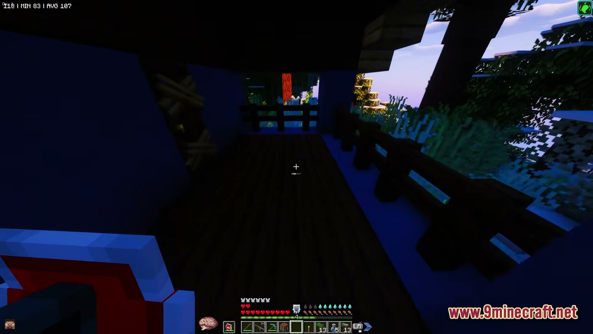 ZOMBIEMANIA A Modern Zombie Apocalypse Modpack Screenshot 5 A player stands on a dark wooden balcony overlooking a dense forest at dusk