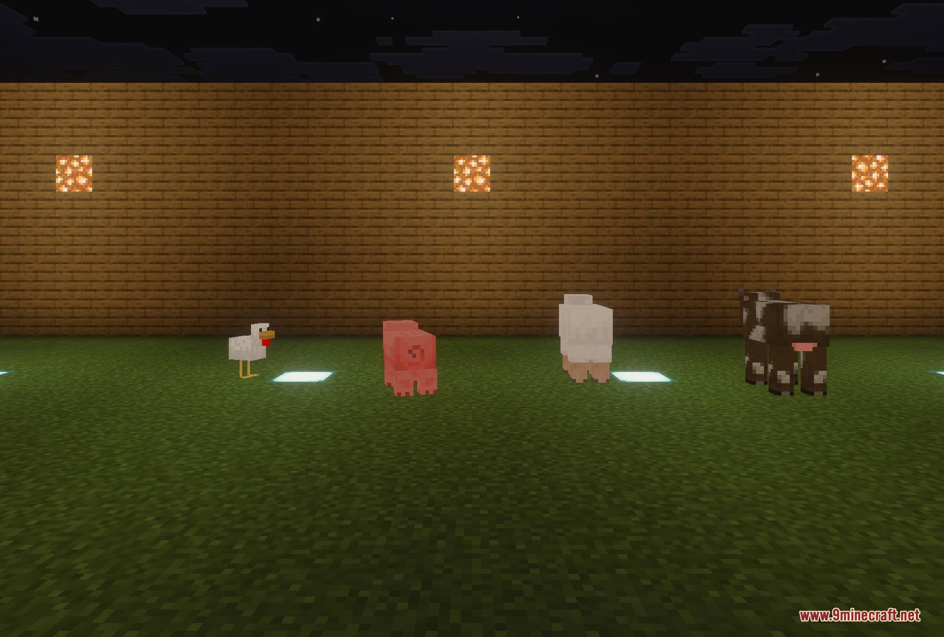Cows, sheep, a pig and a chicken in a lit pen