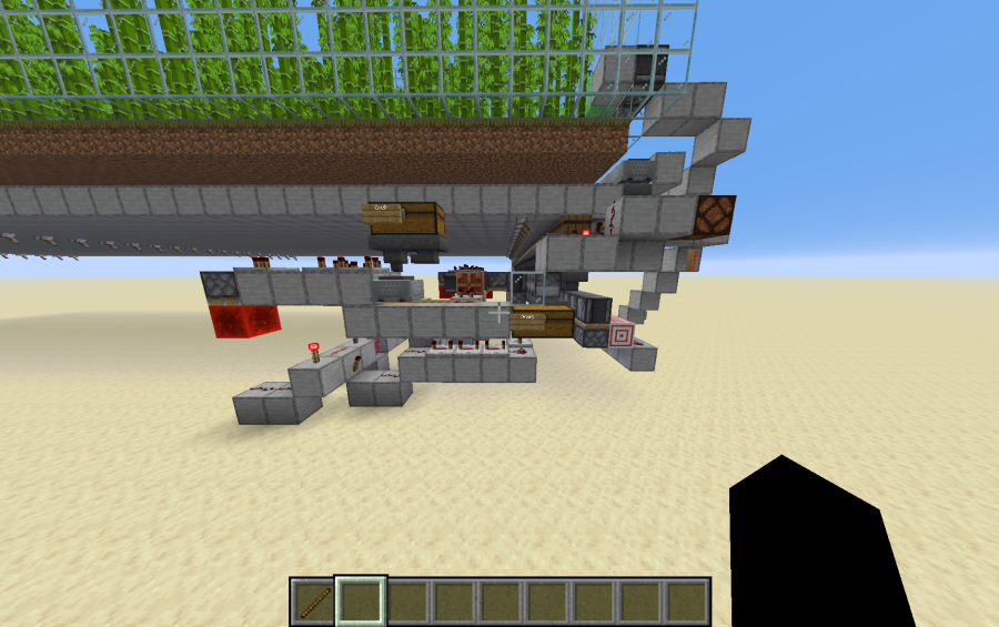 Side view of complex redstone wiring and chests for automated smelting