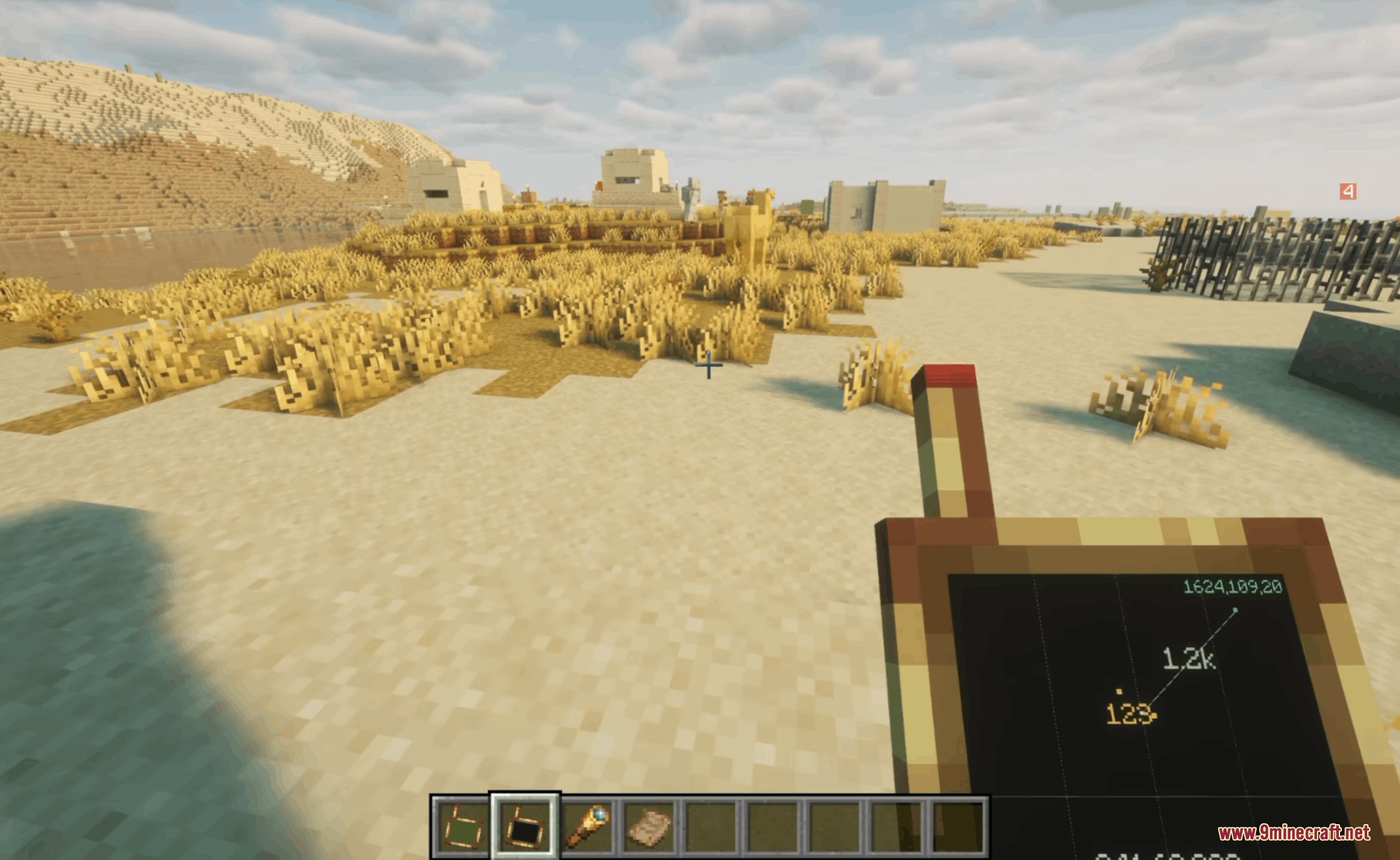 Aetheric Signal Grid Mod Screenshot 2 Player holding a handheld signal tracker device in a desert village biome