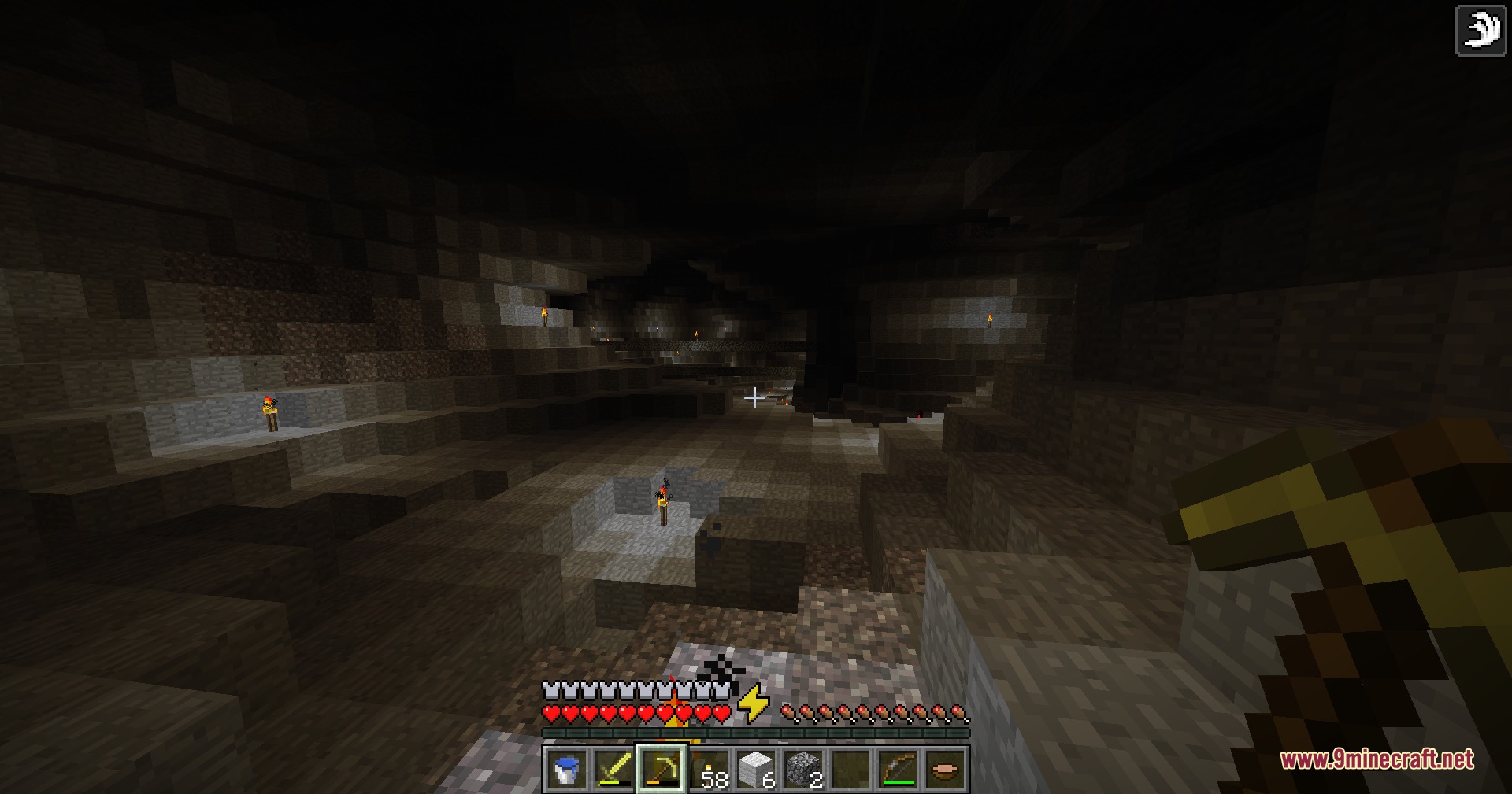 Alpha Horizon Modernized Mod Screenshot 7 A player explores a dark underground cave lit by several wall torches