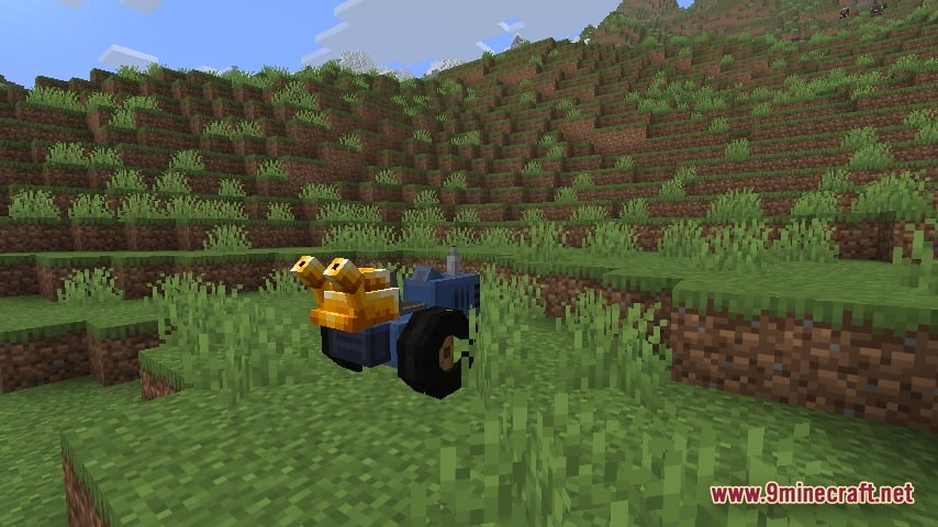 Automobility 9minecraft Mod Screenshot 2 Custom blue tractor parked in a grassy field in Minecraft