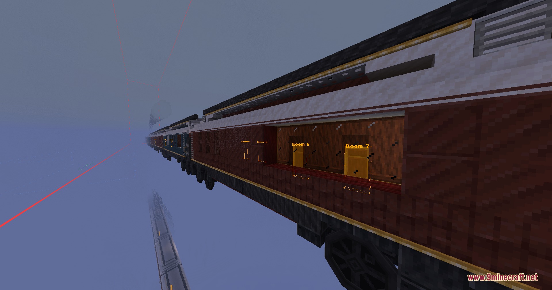 A long passenger train with labeled rooms traveling through a foggy environment