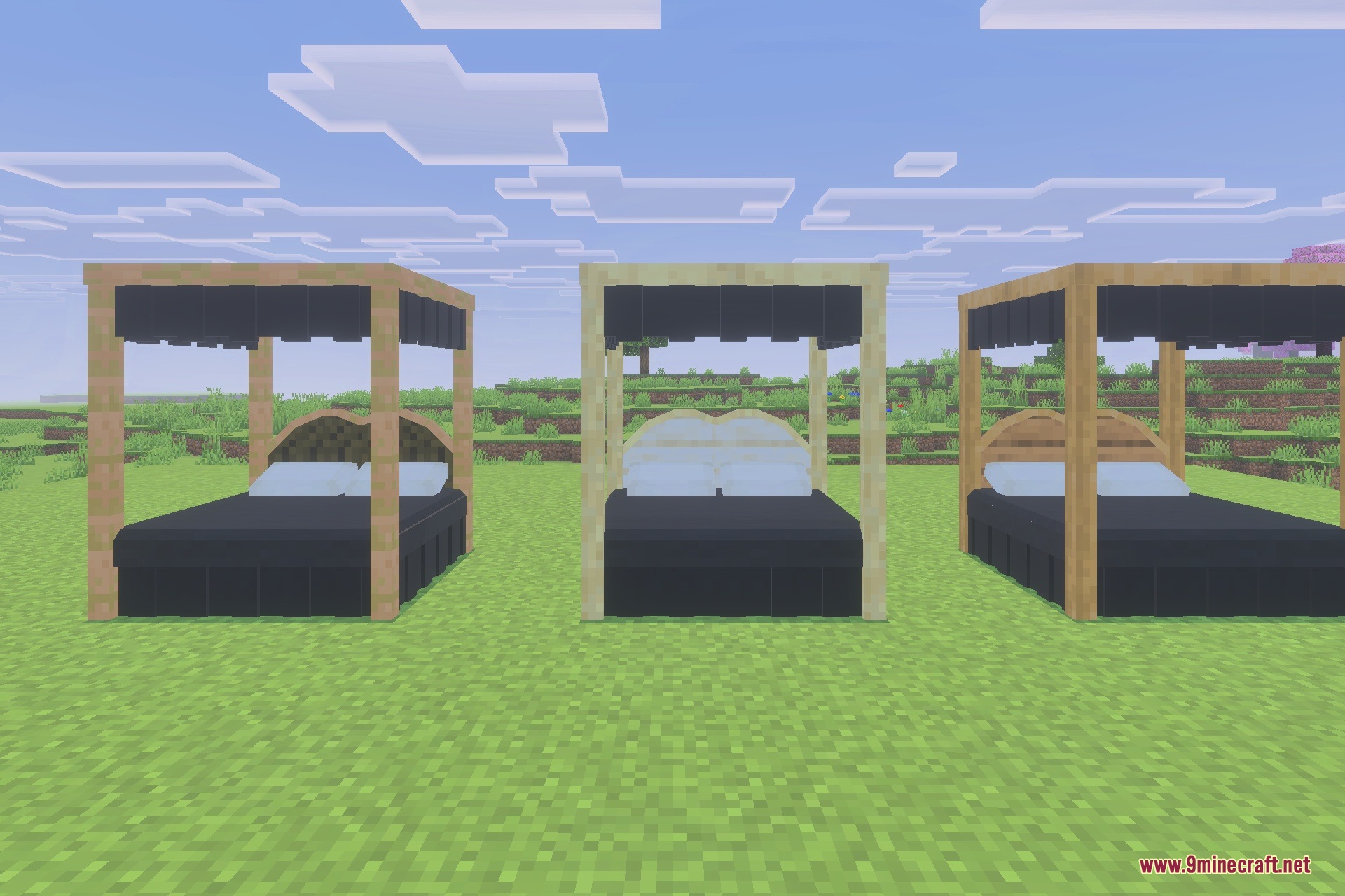 Three canopy beds with black bedding and different wood frames on grass