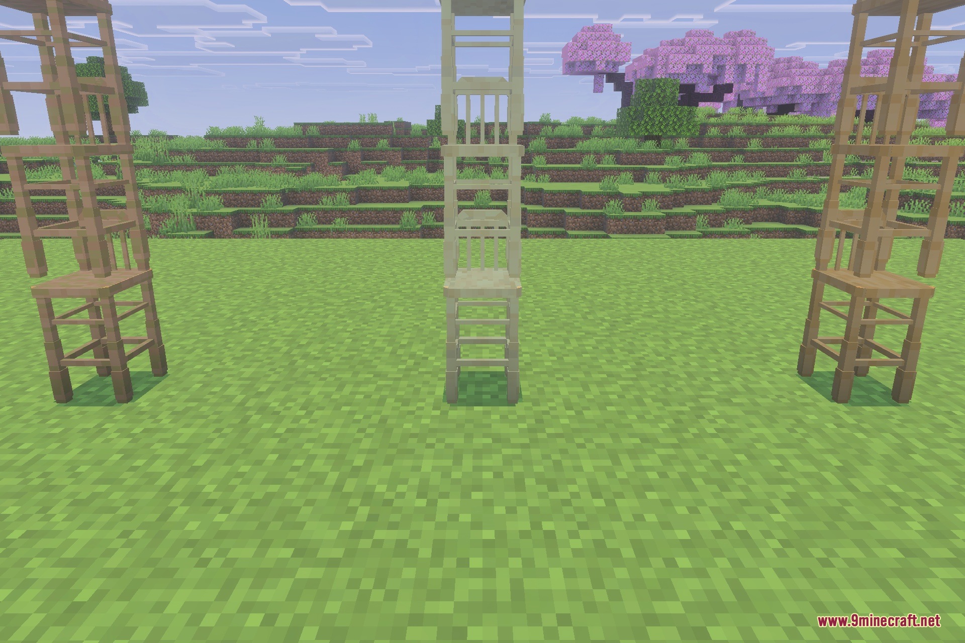 Three tall wooden barstool structures standing on a grassy field in Minecraft