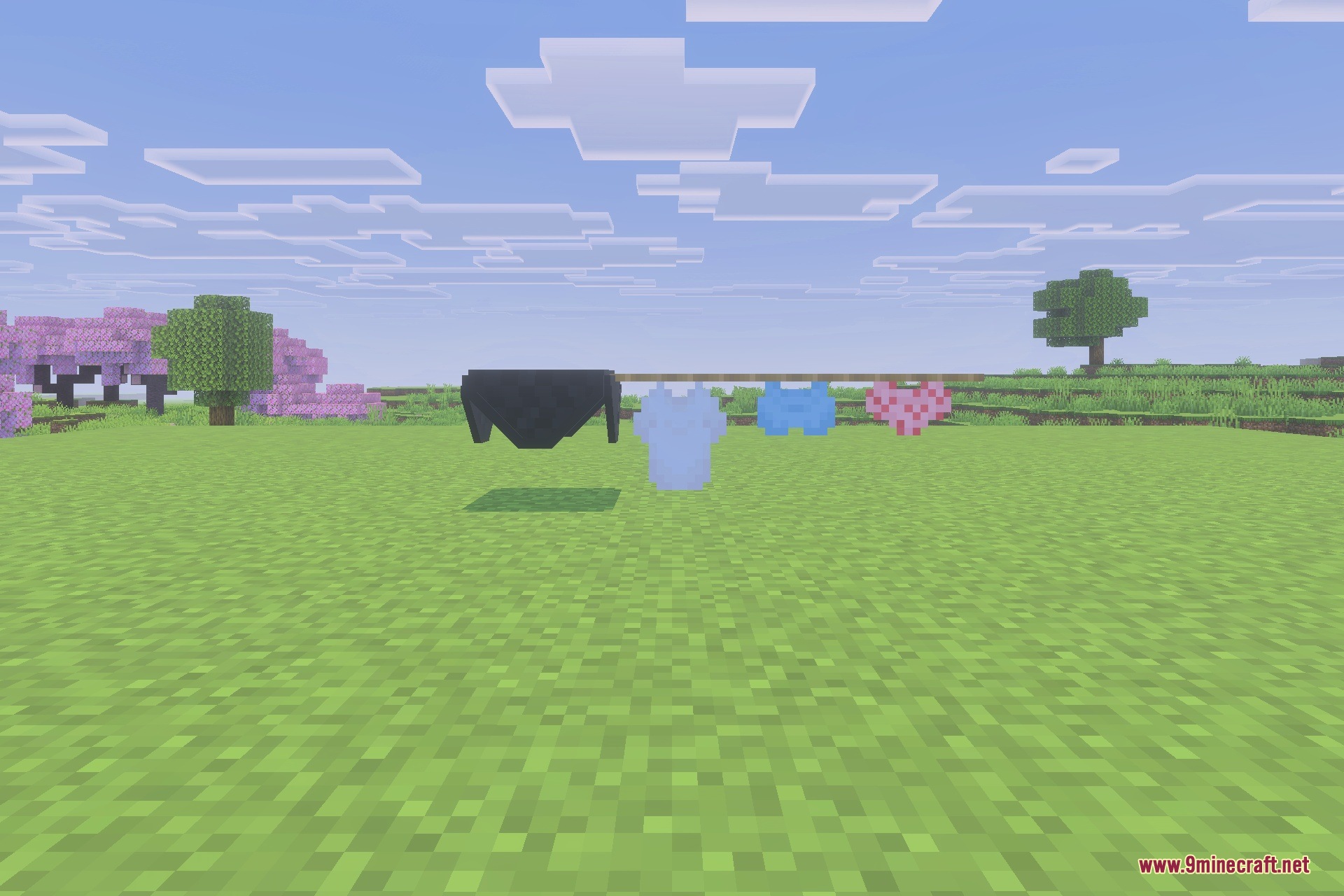 Colorful clothing items hanging in the air on an invisible decorative clothesline