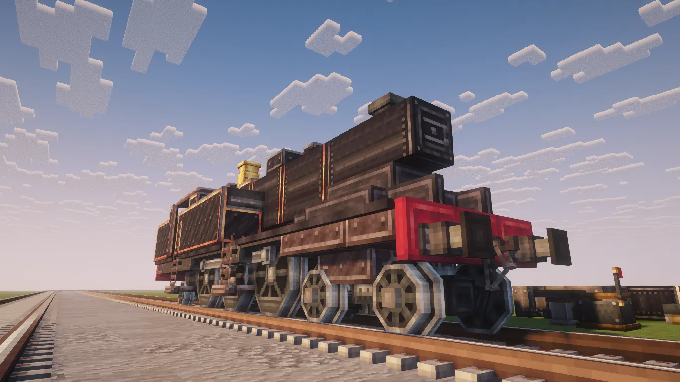 A front perspective of a black steam engine parked on a long track