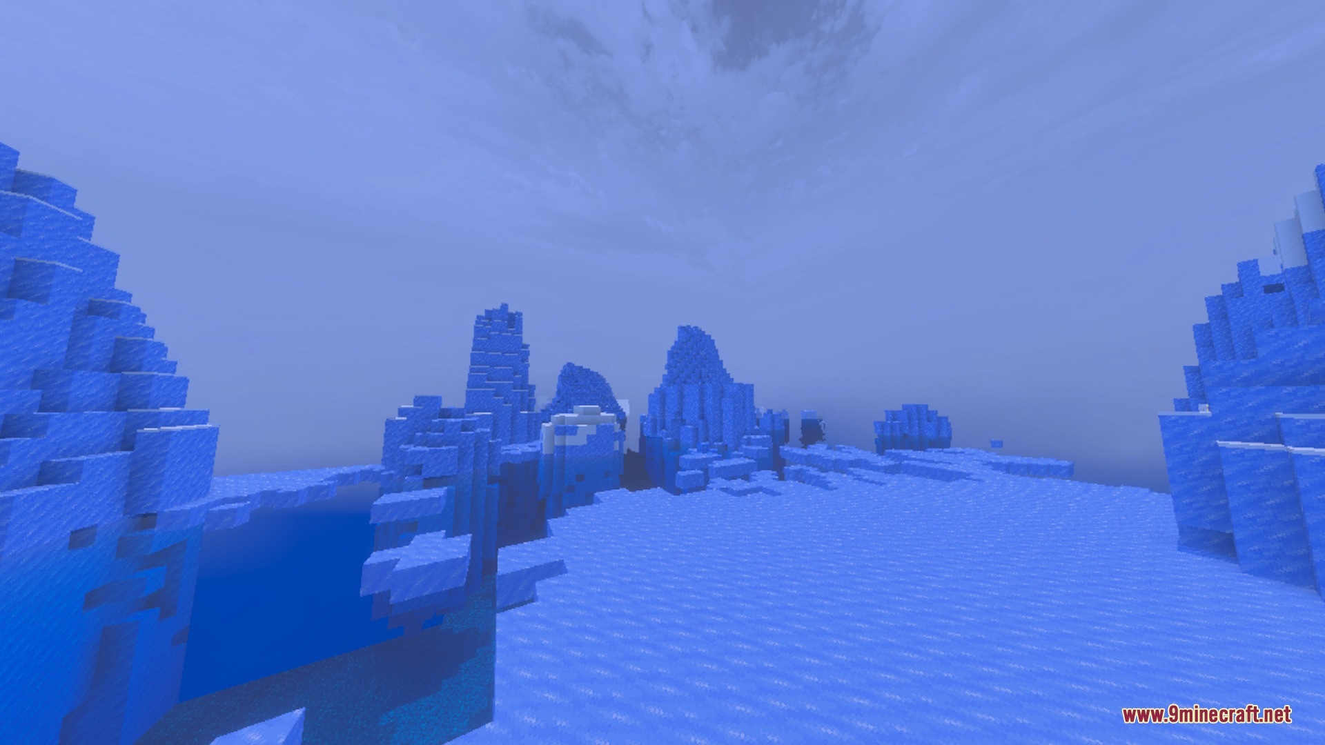 Massive blue ice spikes rise under a clear and detailed cloudy sky