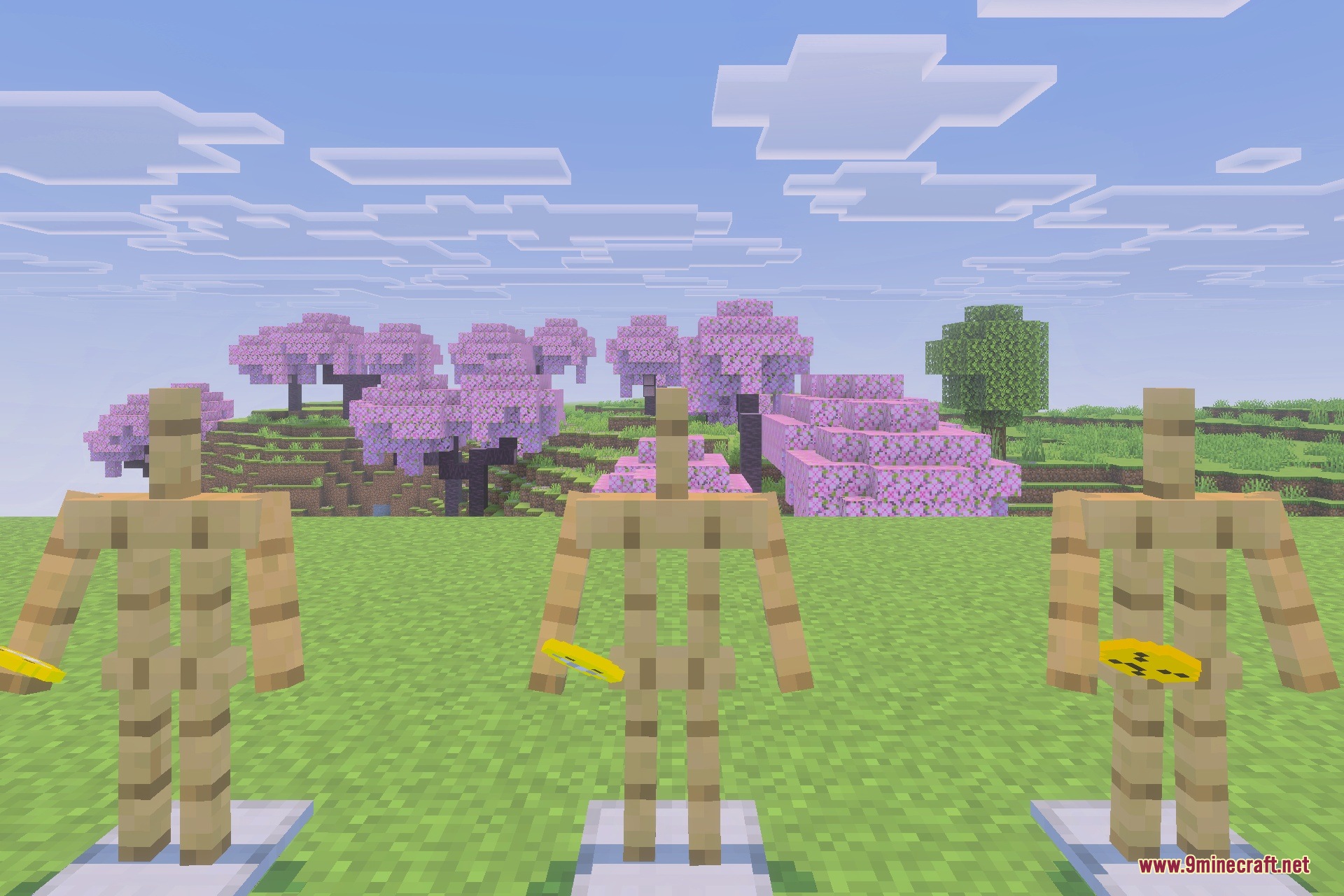 Three armor stands holding yellow items in front of cherry blossom trees