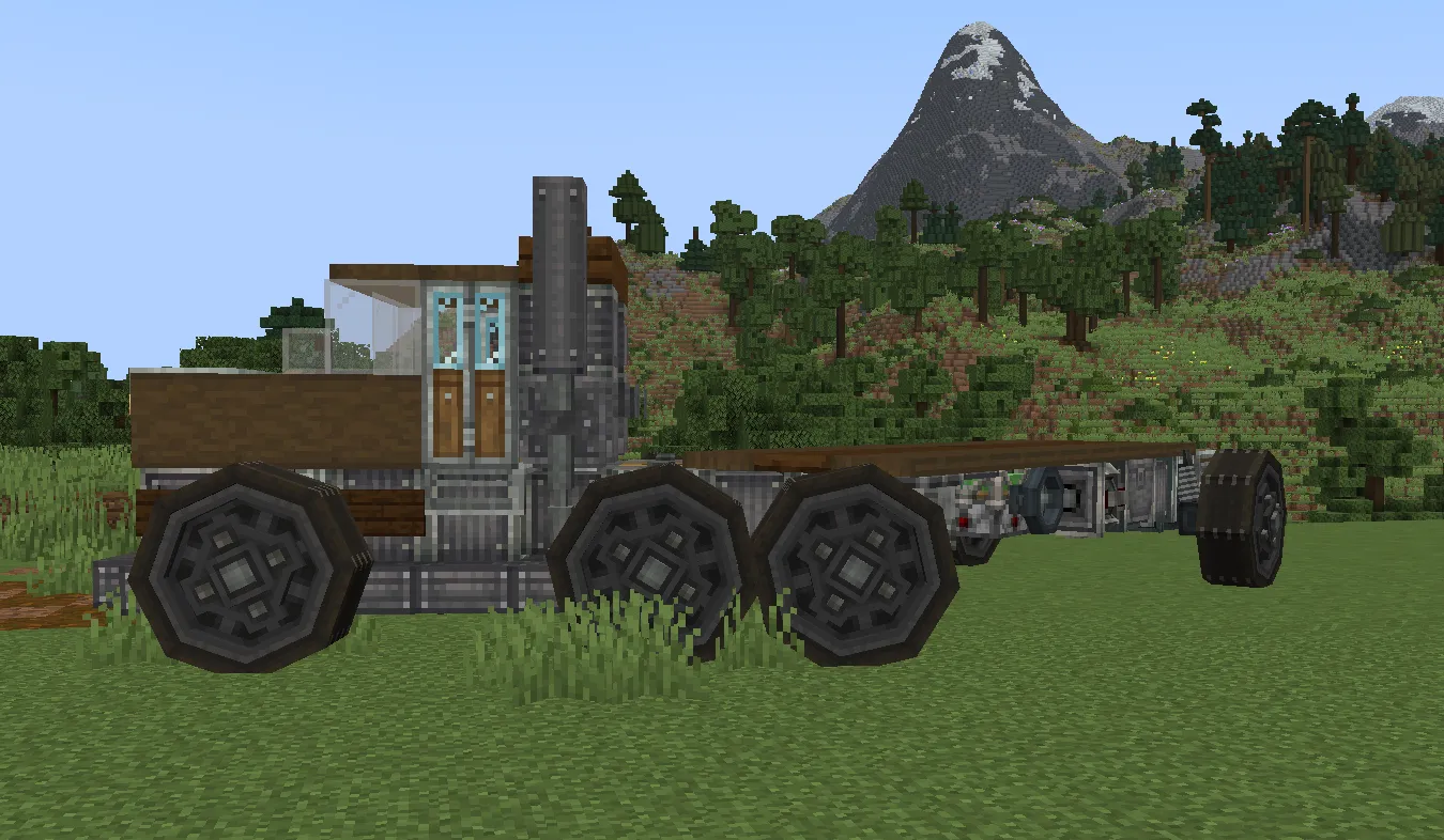 Side profile of a long mechanical truck chassis in a grassy field