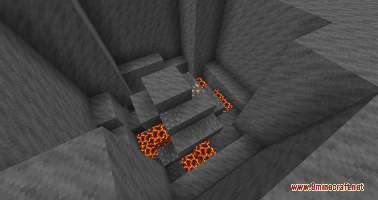 Looking down into a deep pit filled with magma blocks and stone