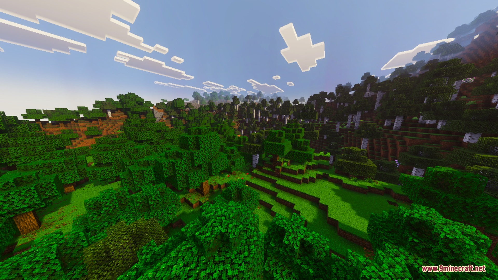 A lush green forest landscape with rolling hills under a bright blue sky