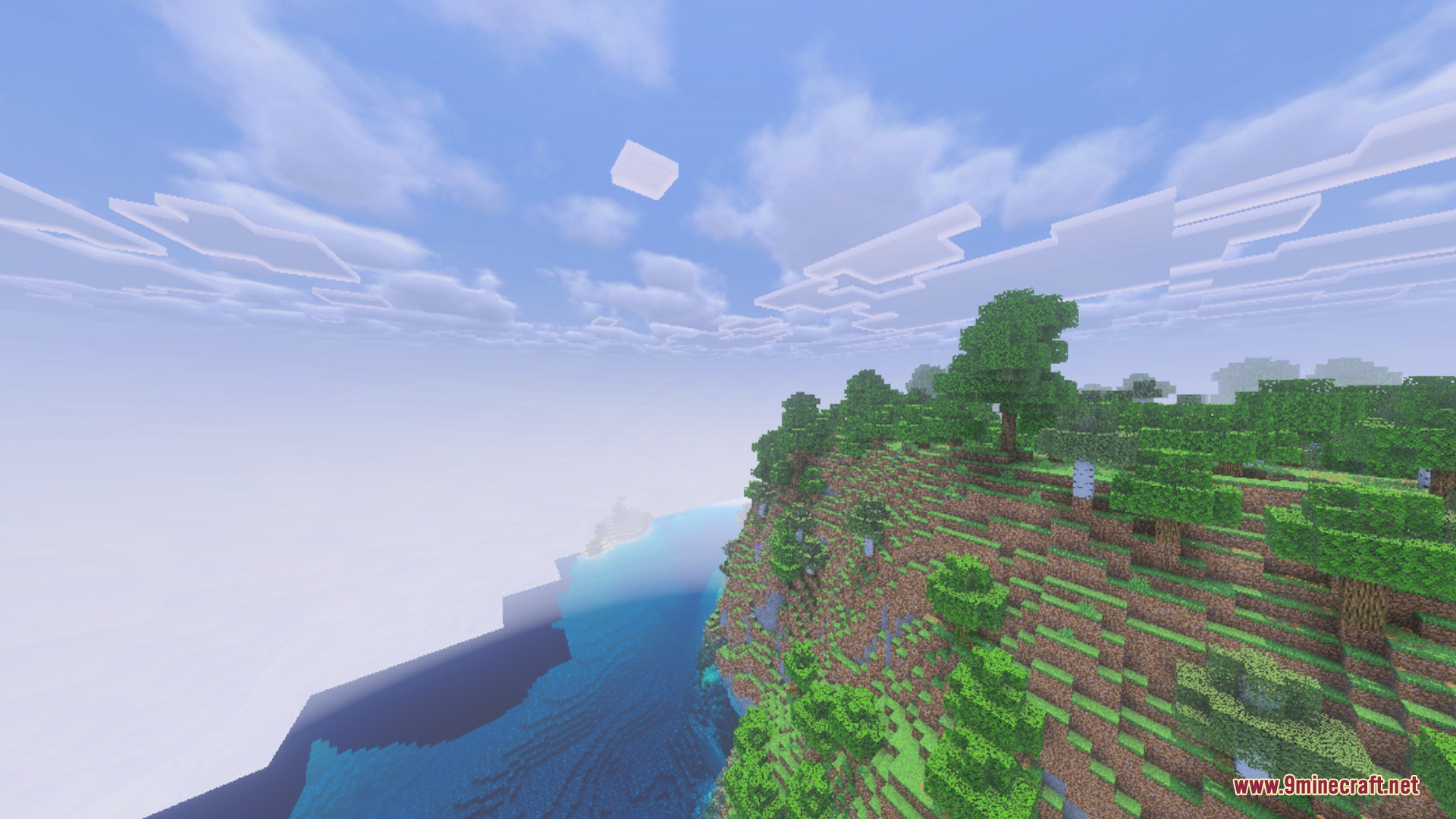 Complementary Unbound Clouds shader showing soft white clouds over a steep cliffside