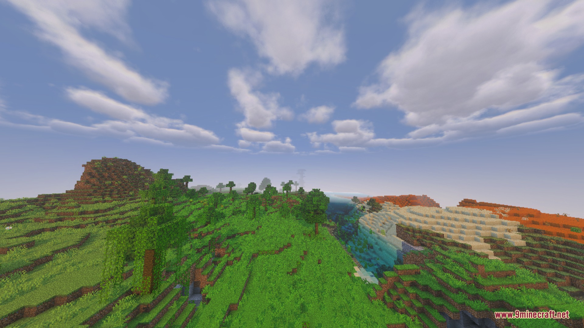 Lush green hills and a river under a bright sky with fluffy clouds